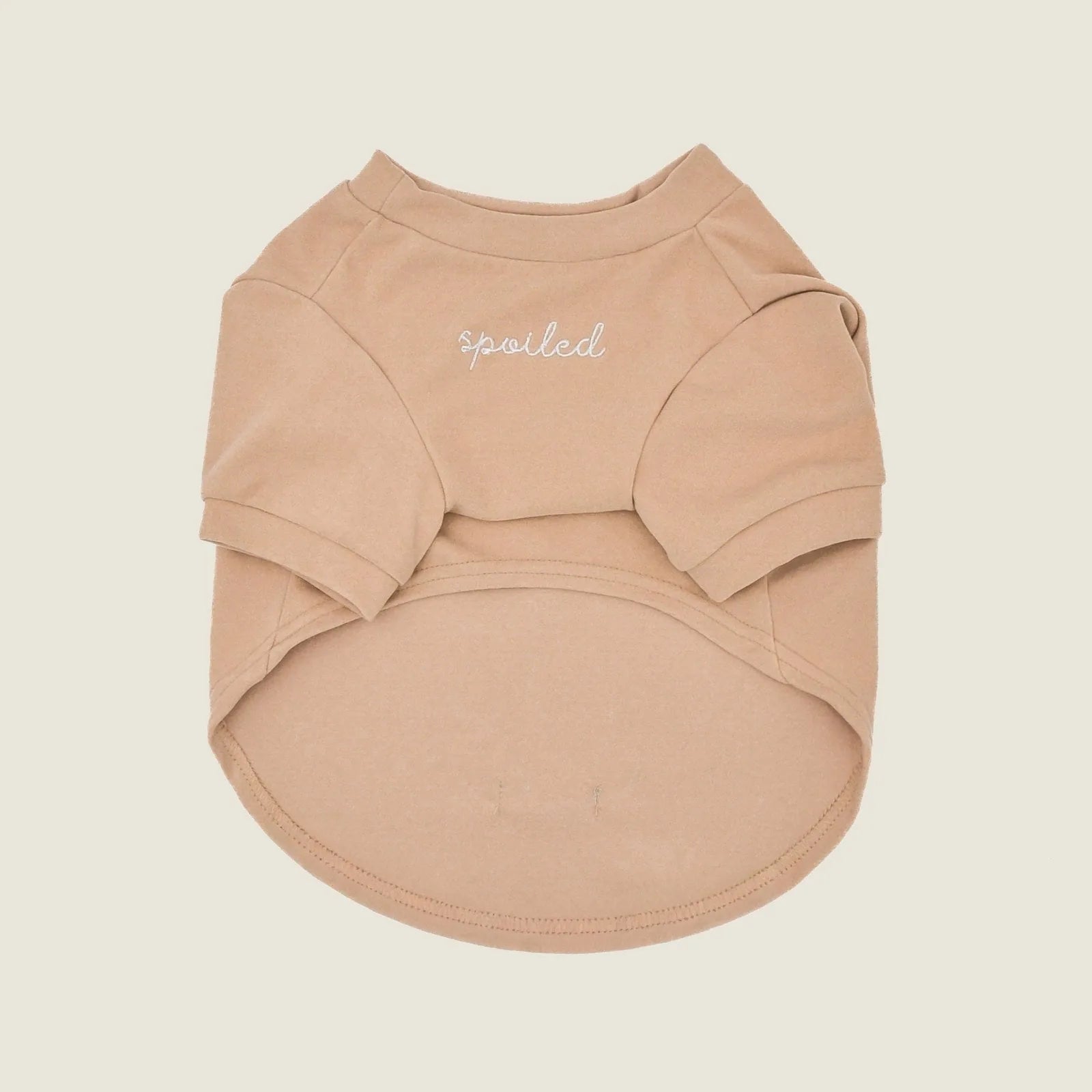 Soft, tan fleece dog shirt with "spoiled" embroidery and mock neck, designed for comfort and style.
