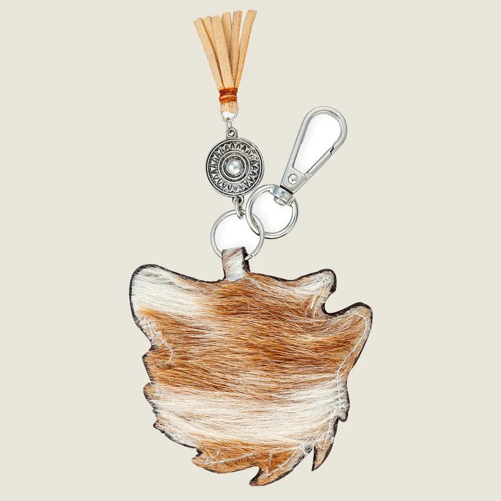Brown dog-shaped key fob made of leather, featuring a metal ring and leather tassel for a stylish touch.