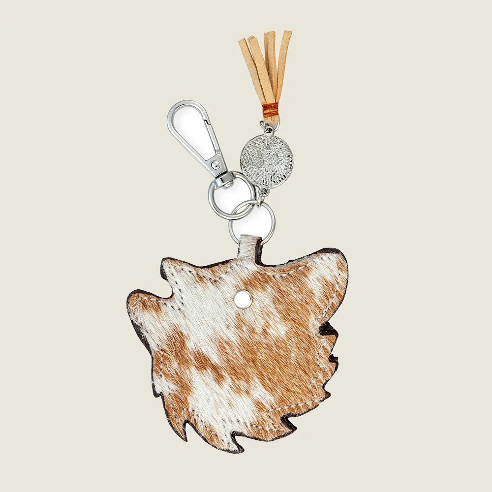 Brown leather key fob in a dog shape with a silver metal ring and tassel, perfect for dog lovers.