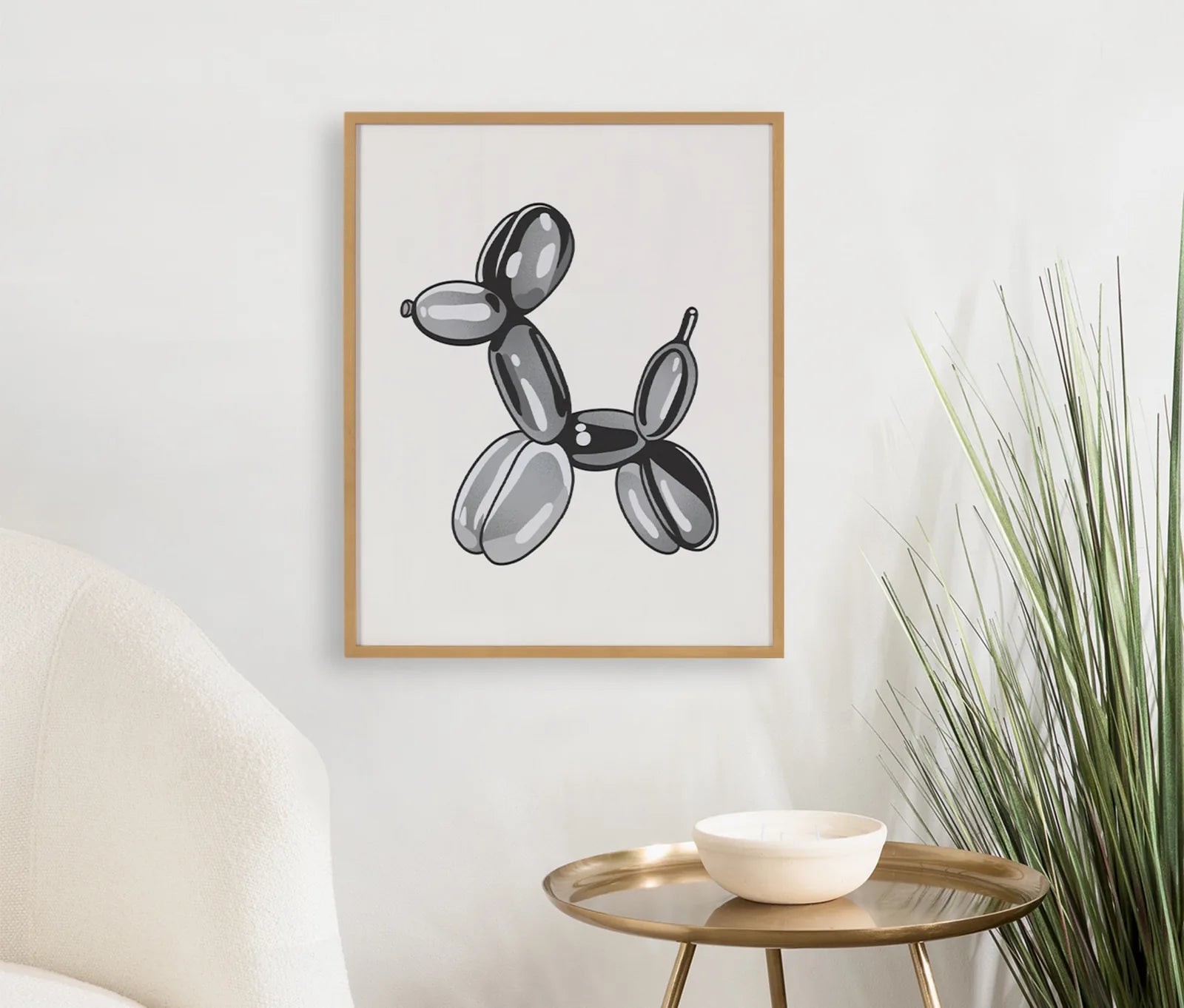Framed black balloon dog art against a white wall, featuring a natural wood frame and modern decor accents.