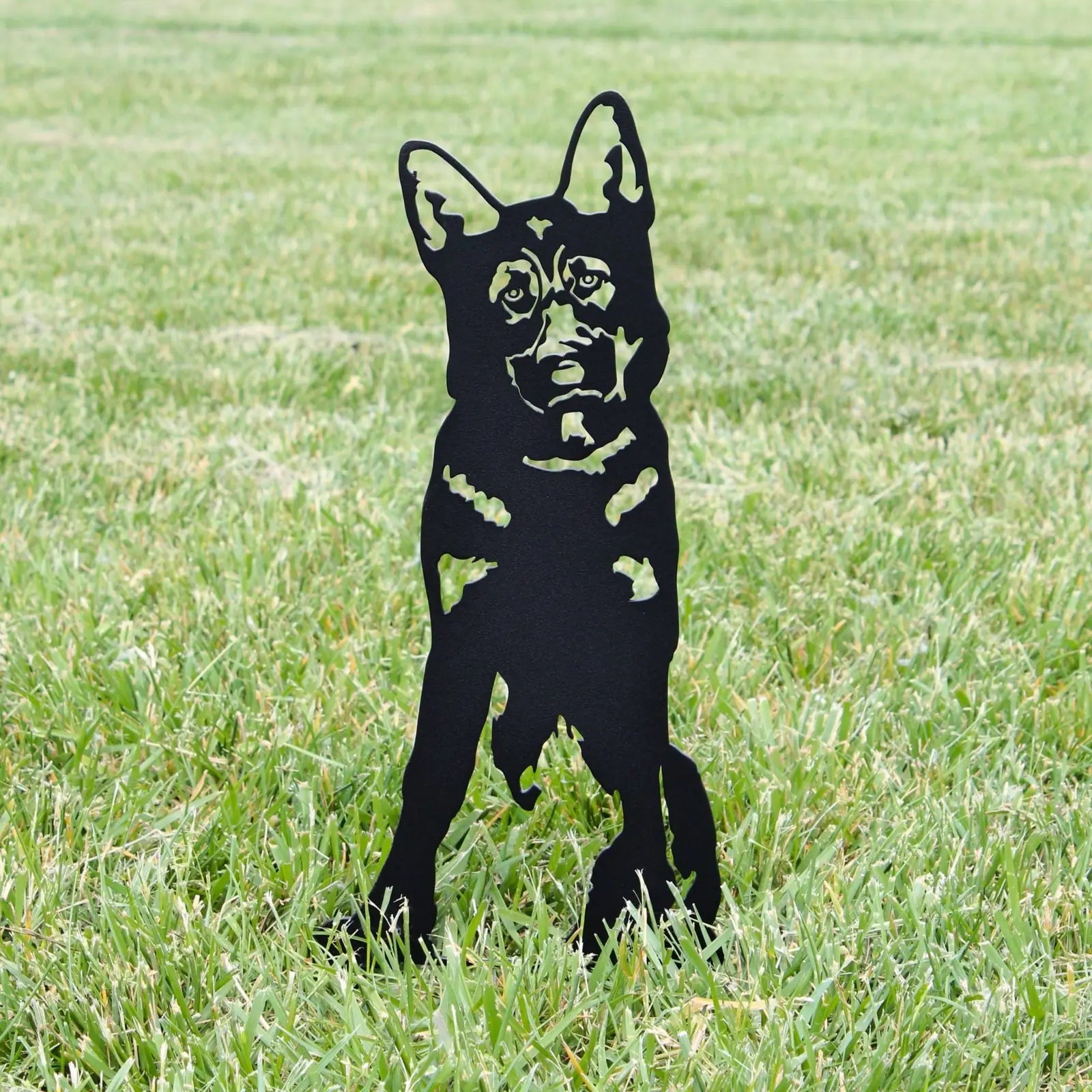 German Shepherd metal silhouette in black, standing on green grass, perfect for garden decoration.