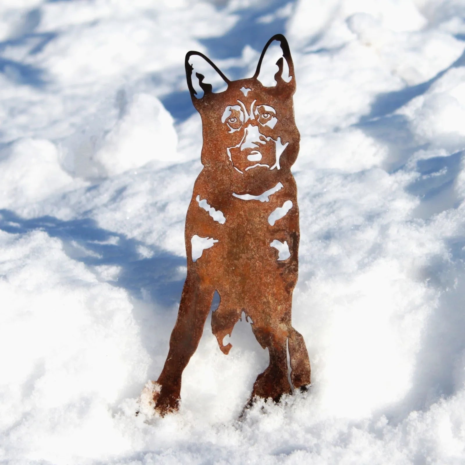 German Shepherd metal silhouette in rusted Corten steel standing in snow, ideal for garden decor by My Metal Rescue.