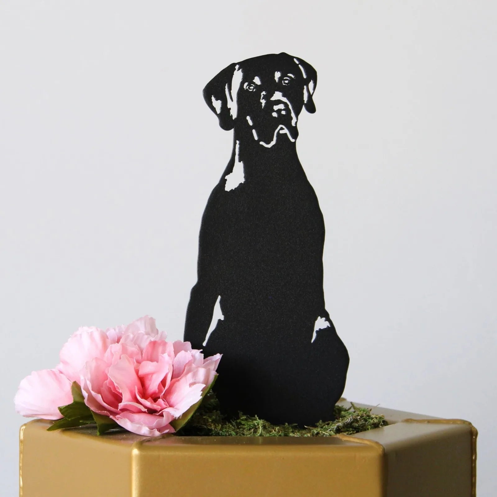 Black metal silhouette of a German Shorthaired Pointer, accented with pink flowers, showcasing outdoor decor elegance.