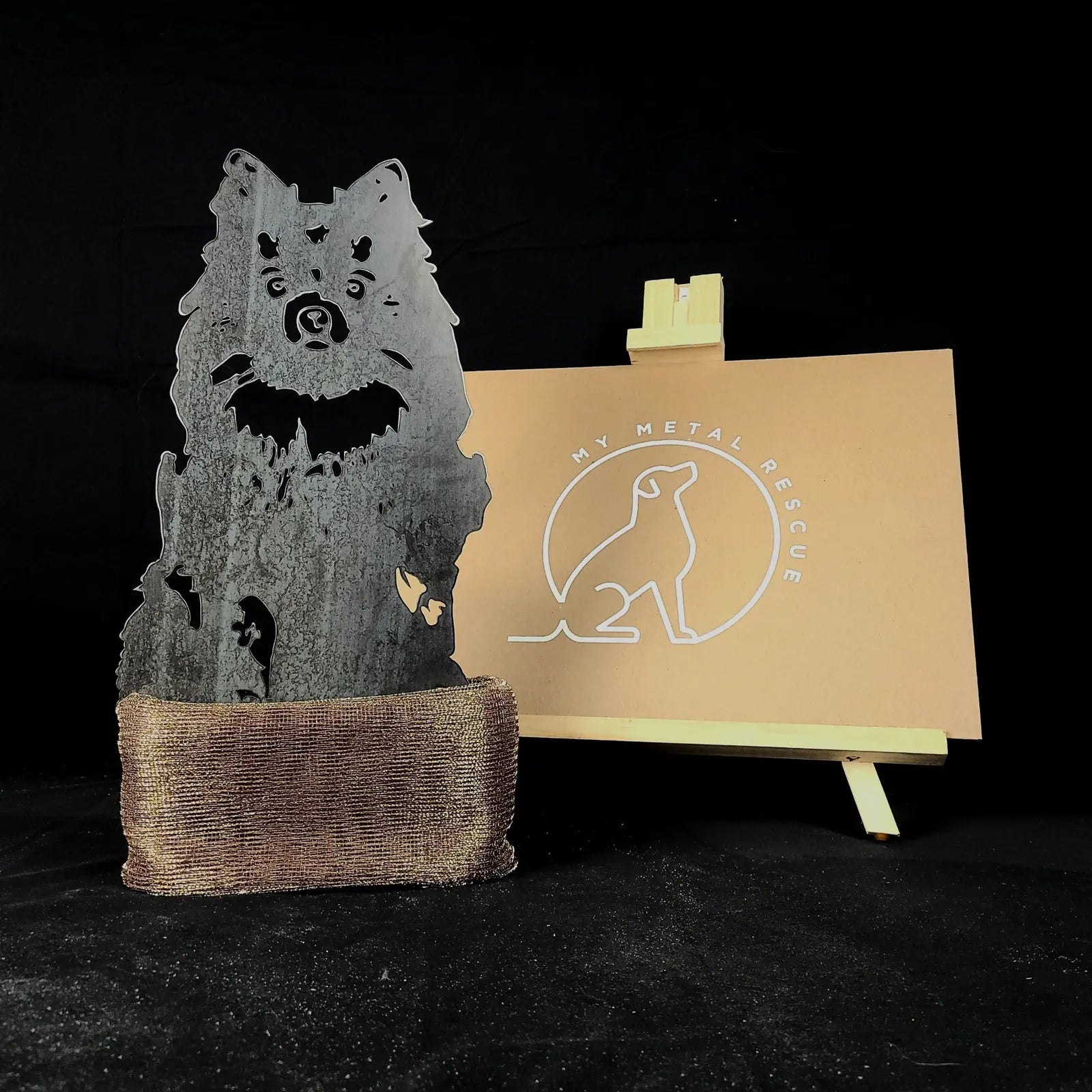 Handmade metal silhouette of a German Spitz in Corten steel, featuring a rustic finish and sturdy base for display.