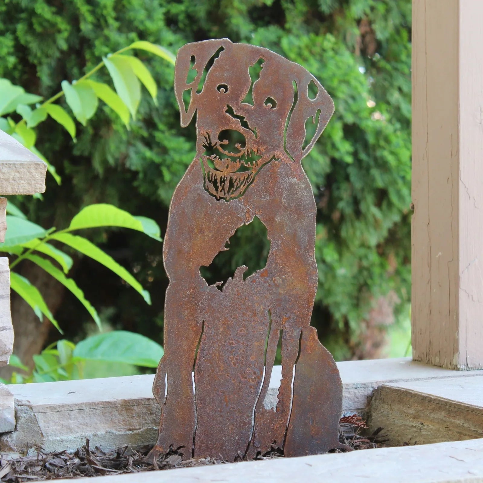Rustic metal silhouette of a dog, made from weathering steel, showcasing a patina finish perfect for outdoor decor.