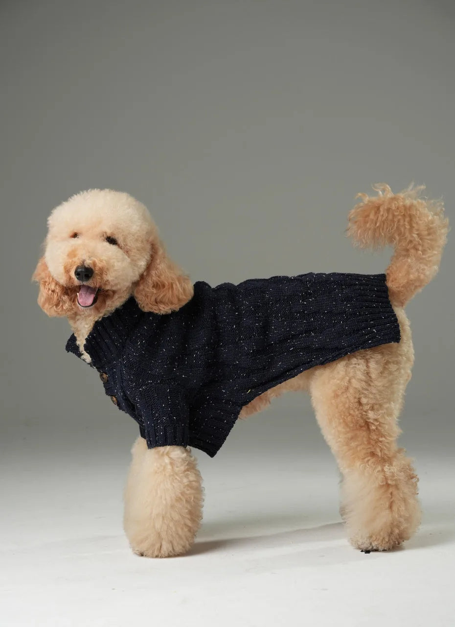 Navy textured knit pet sweater with vintage chest buttons, designed for comfort and warmth on a fluffy dog.