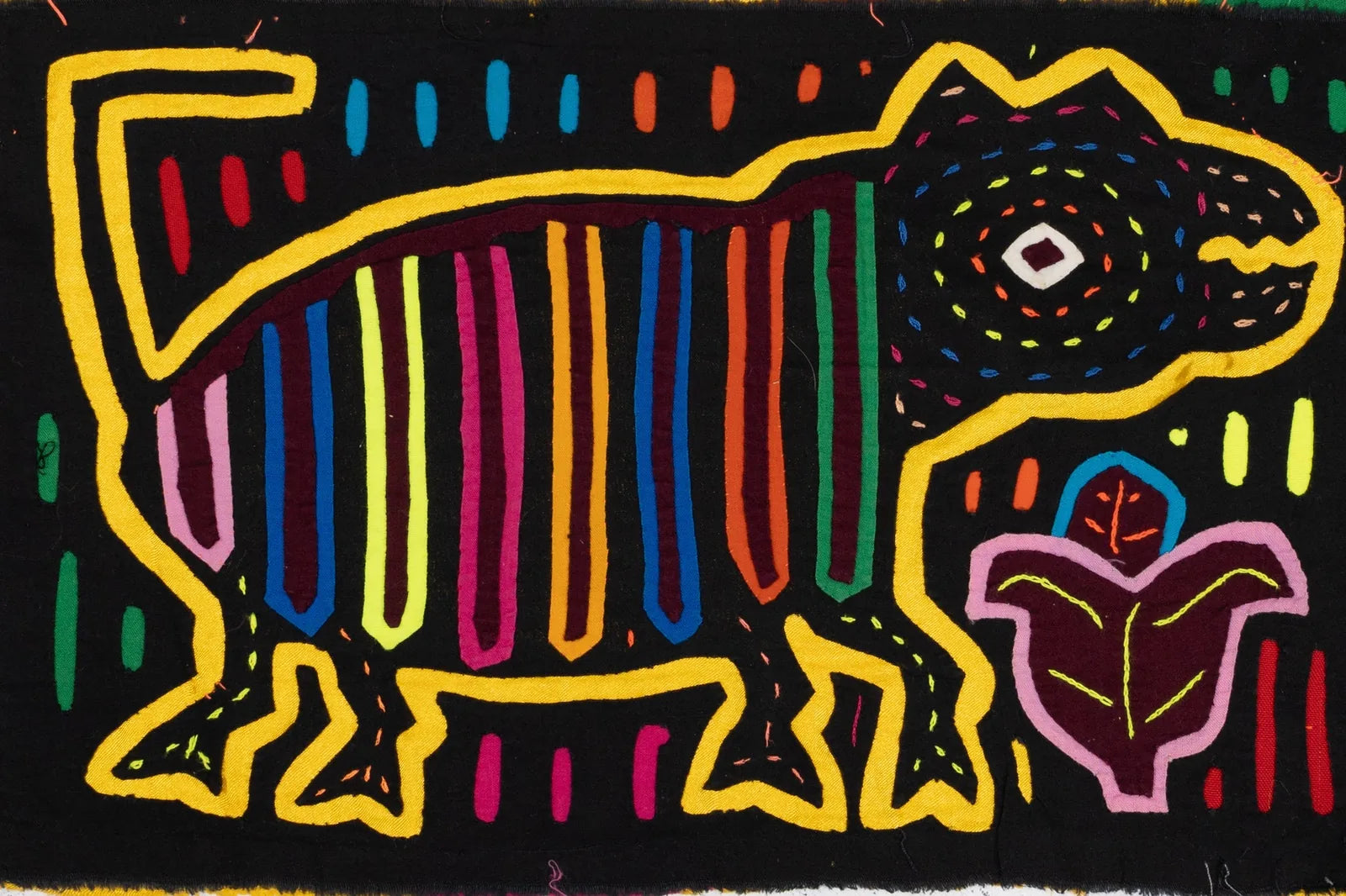 Hand-stitched golden retriever puppy in vibrant colors against a black background, showcasing unique Mola textile art.