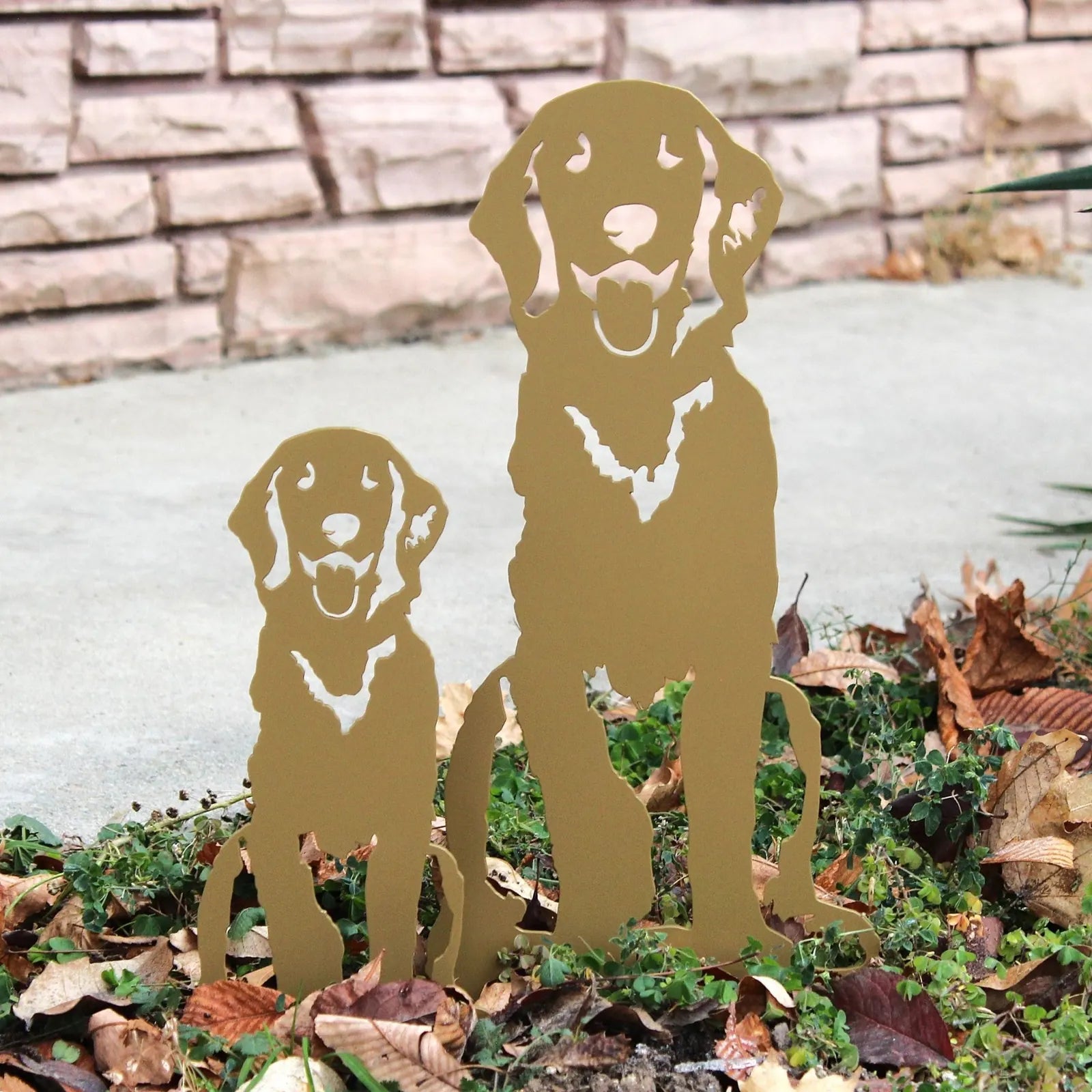 Golden Retriever silhouette metal art in warm gold, featuring a large and small dog, surrounded by autumn leaves.