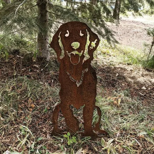Handcrafted rusted metal silhouette of a sitting Golden Retriever amidst greenery, showcasing its joyful expression.