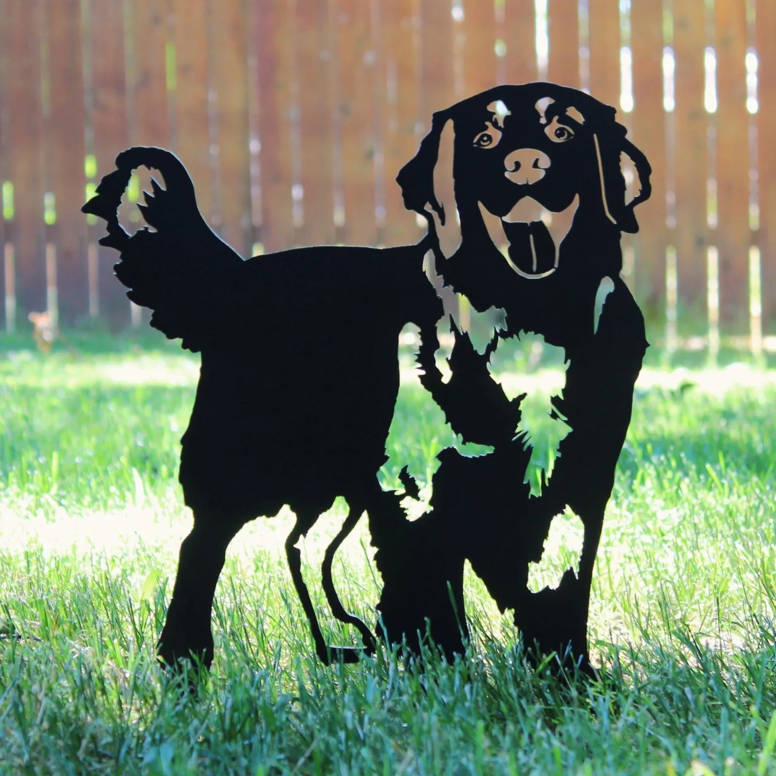 Black metal silhouette of a Golden Retriever standing in grass, showcasing playful detailing and sturdy construction.