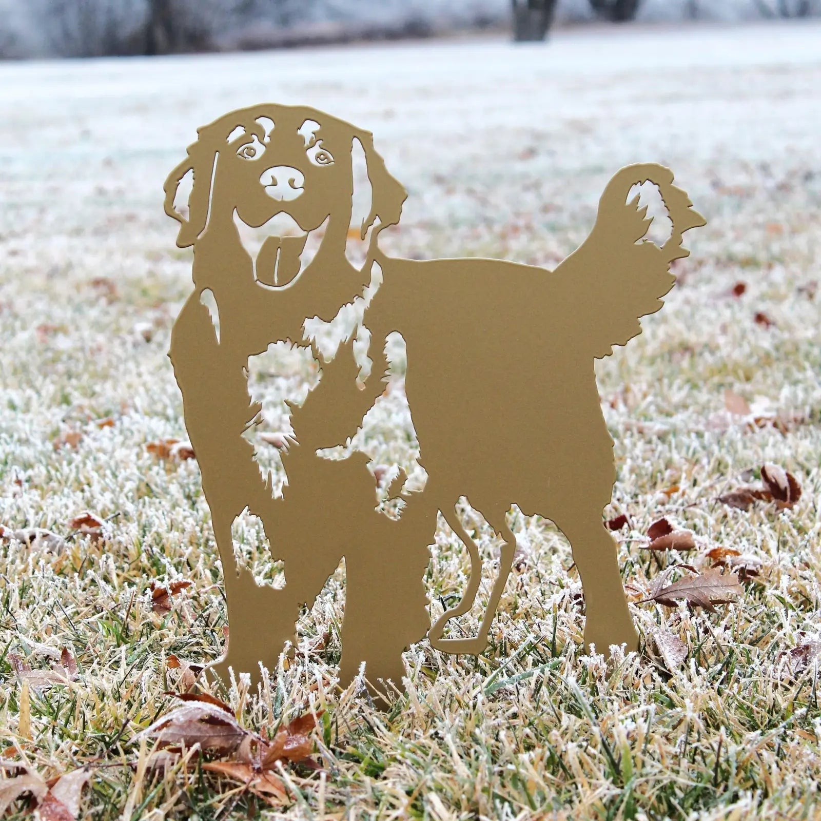 Golden Retriever silhouette in gold metal standing on frosty grass, perfect for outdoor decor and garden accent.