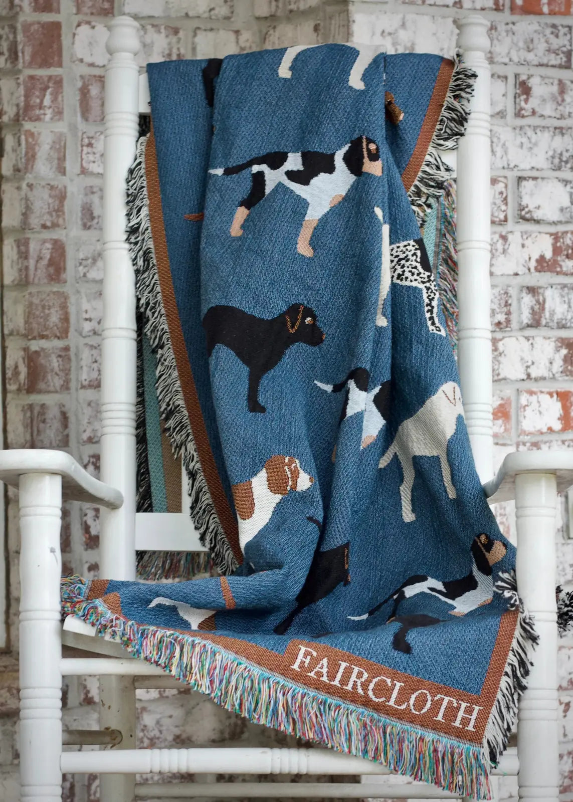 Slate blue throw blanket featuring hand-drawn dog breeds, bordered in rust with fringe, perfect for dog lovers.