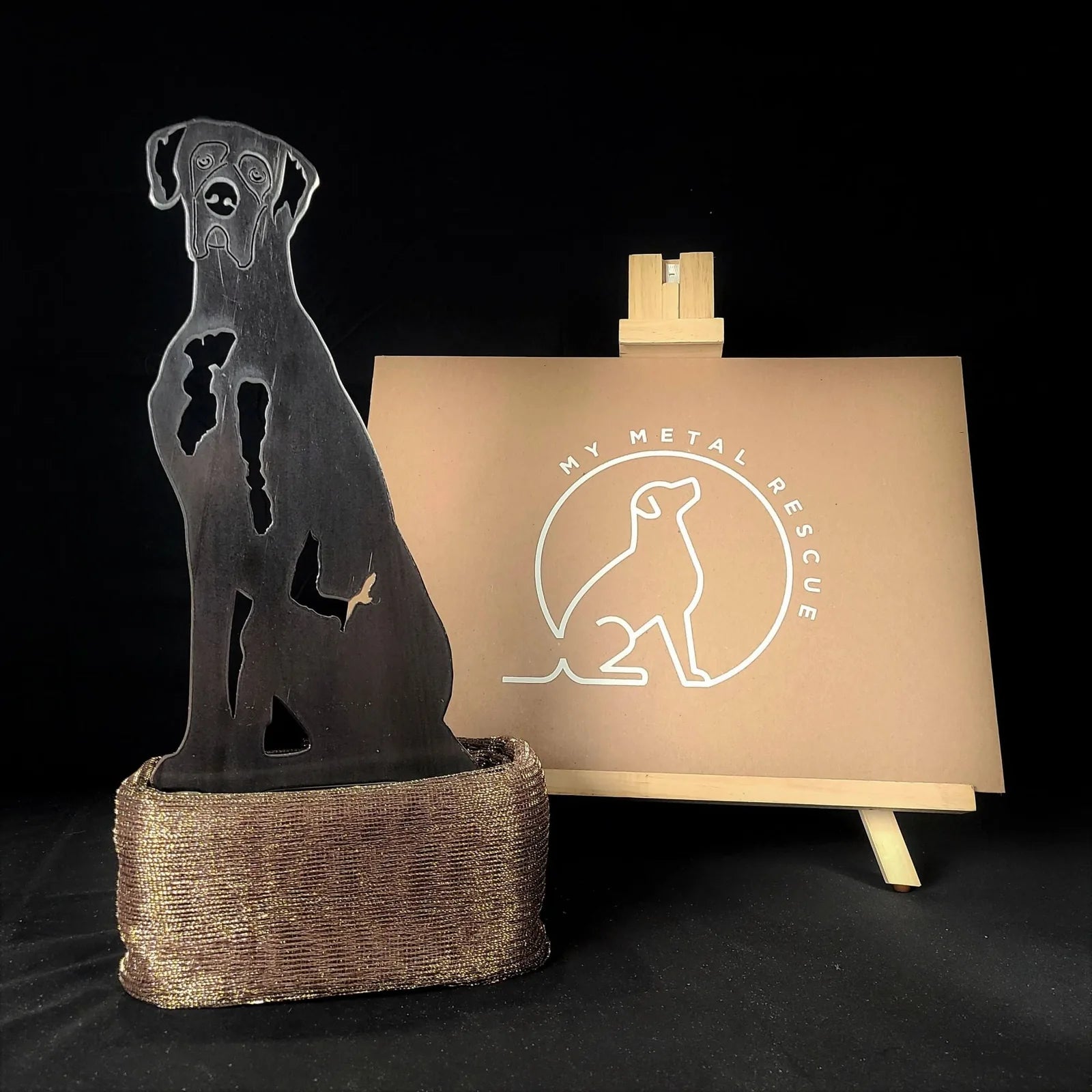 Great Dane silhouette in matte black, displayed with a bronze base and My Metal Rescue logo backdrop.