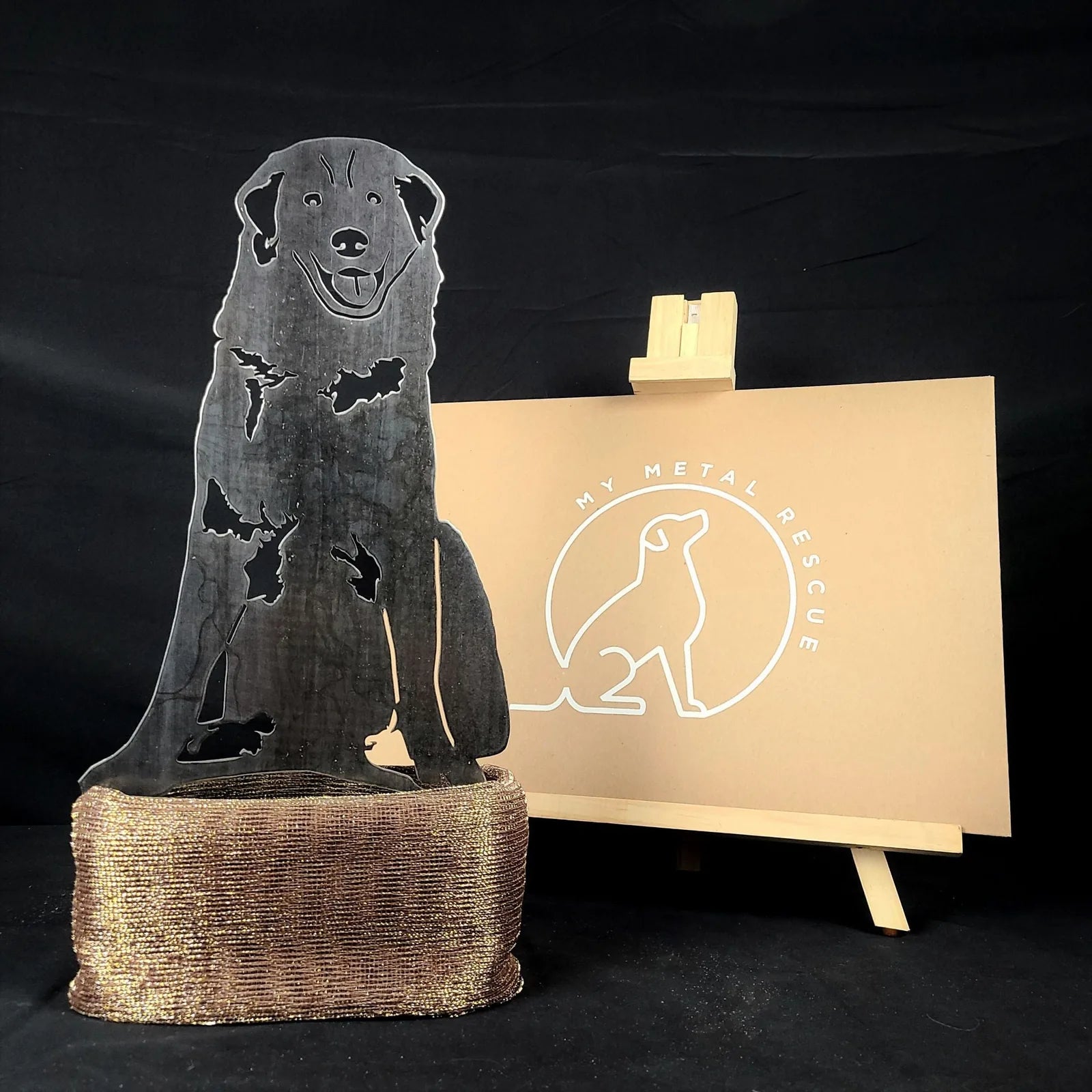 Great Pyrenees silhouette made of black metal, showcasing a seated dog with a textured surface, placed on a textured brown...