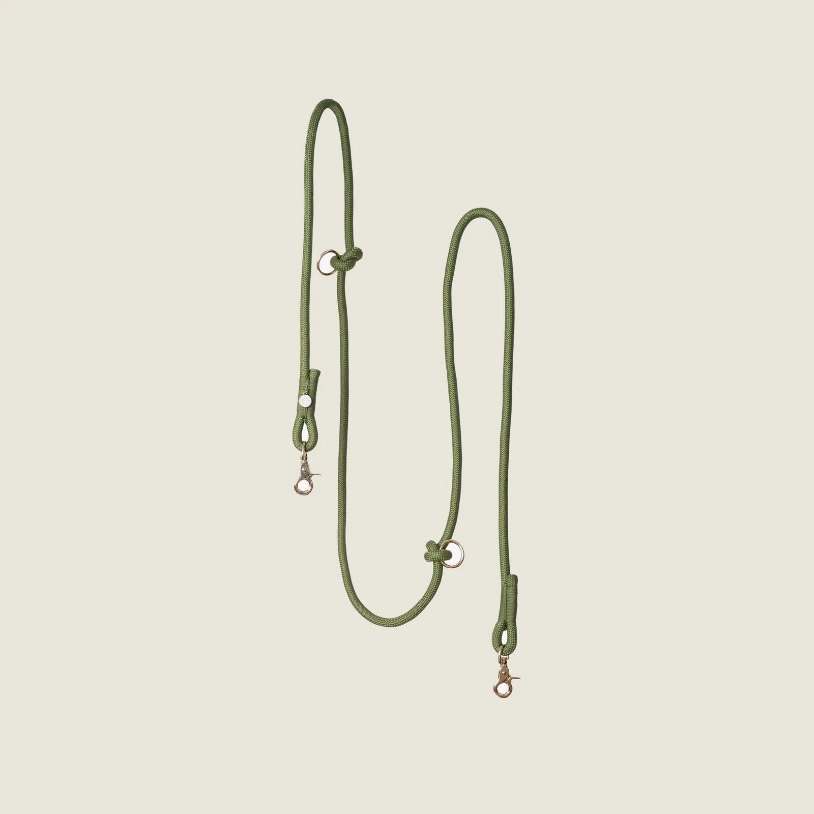 Hands-free braided leash in olive green, featuring metal clasps and adjustable design for walking convenience.