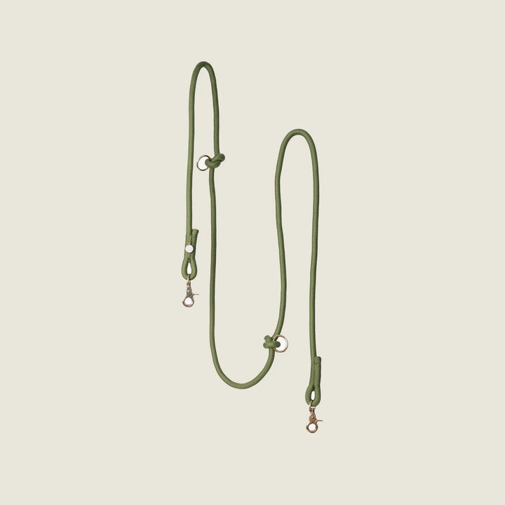 Hands-free braided leash in olive green, featuring metal clasps and adjustable design for walking convenience.