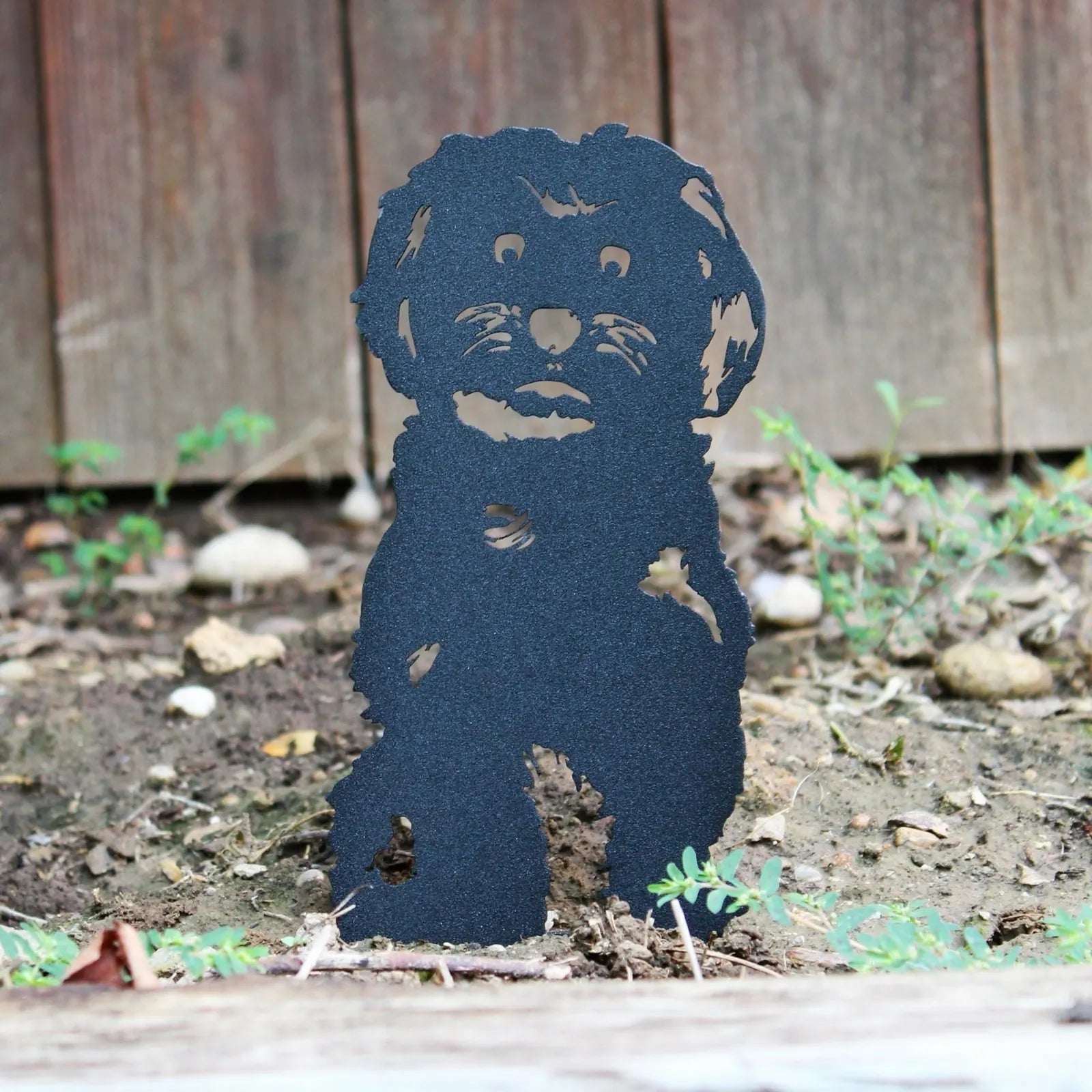 Black Havanese metal silhouette standing in earthy garden soil, showcasing intricate fur details. Ideal for outdoor dog de...