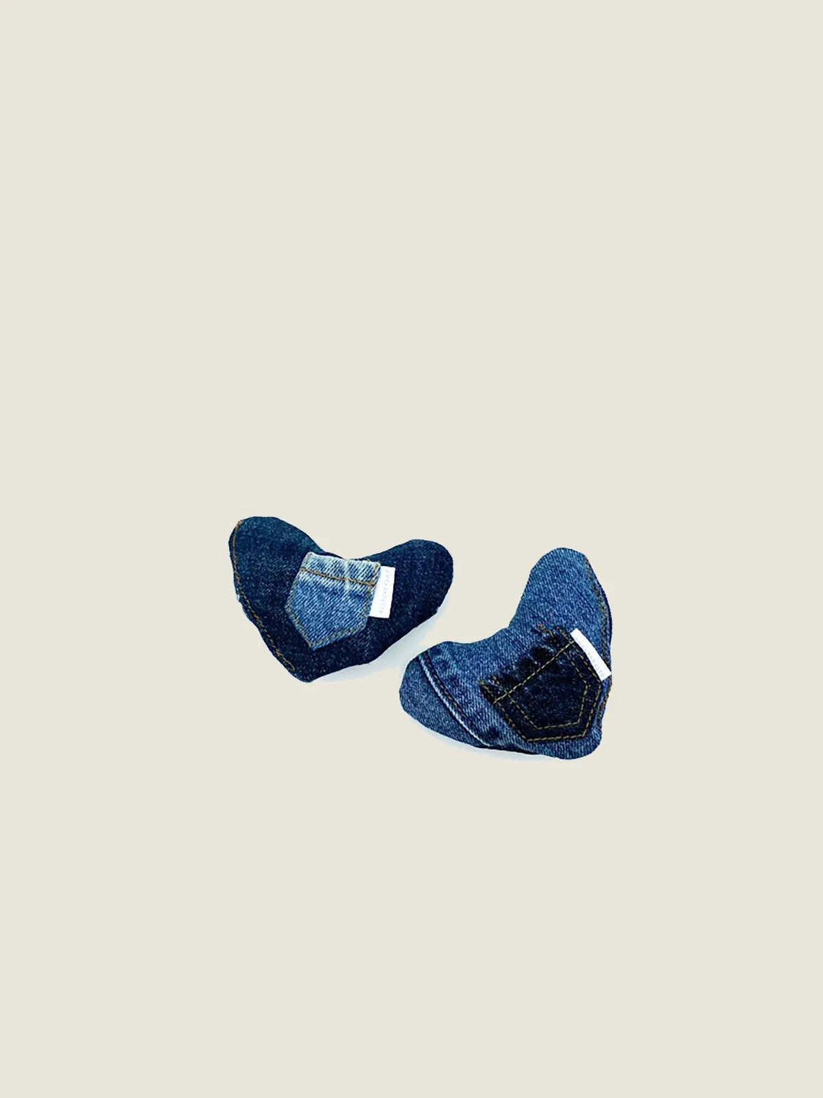 Plush heart-shaped dog toy made from upcycled denim, featuring visible pockets and a soft texture.