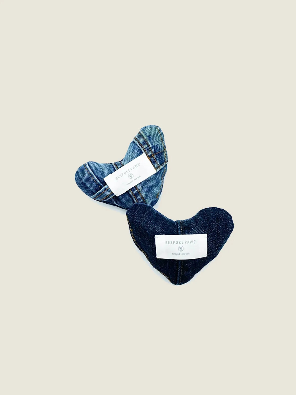 Soft, plush heart-shaped dog toys made from upcycled denim, featuring unique blue fabric patterns and BISPOKE PAWS labels.