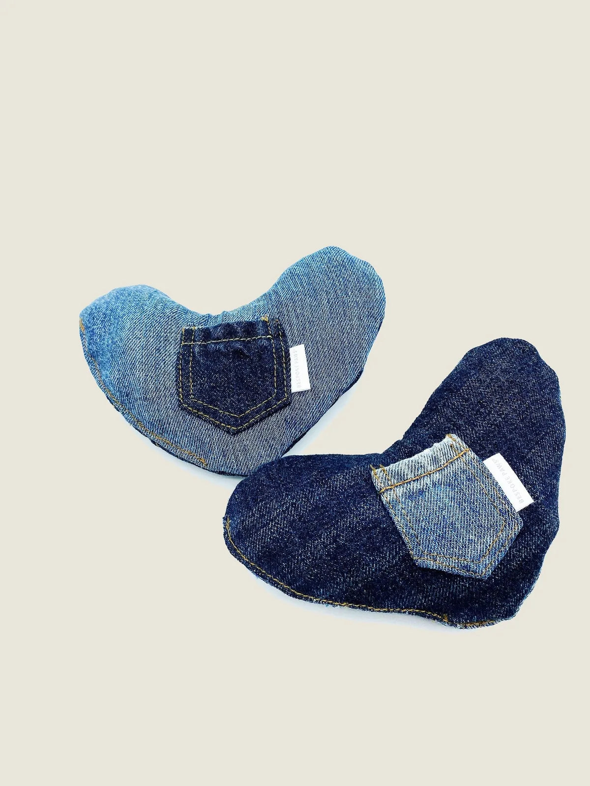 Plush heart-shaped dog toys crafted from upcycled denim, featuring unique pocket designs in blue shades.
