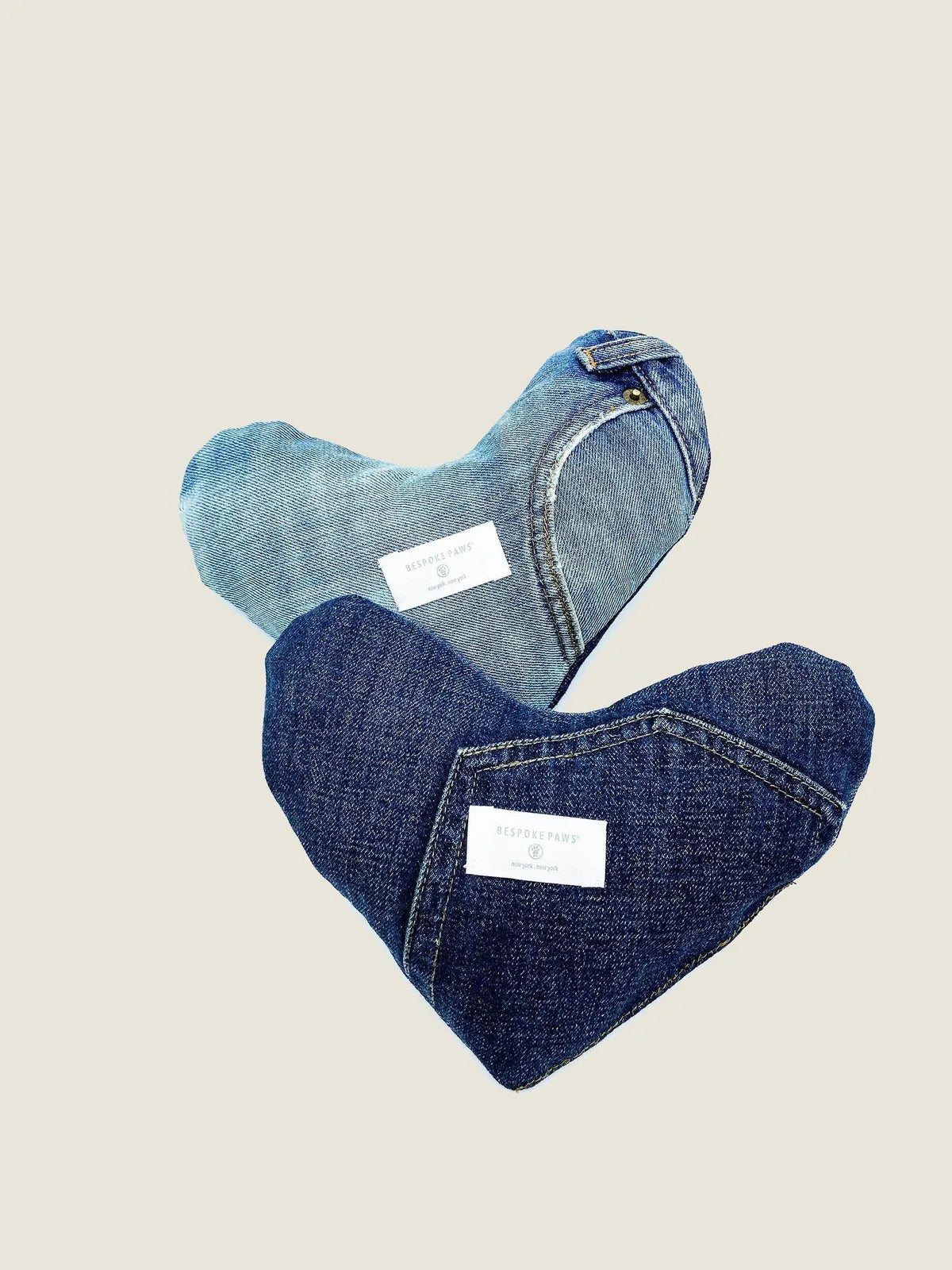 Plush heart-shaped dog toy made from upcycled denim, featuring unique textures and fabric patches in blue tones.