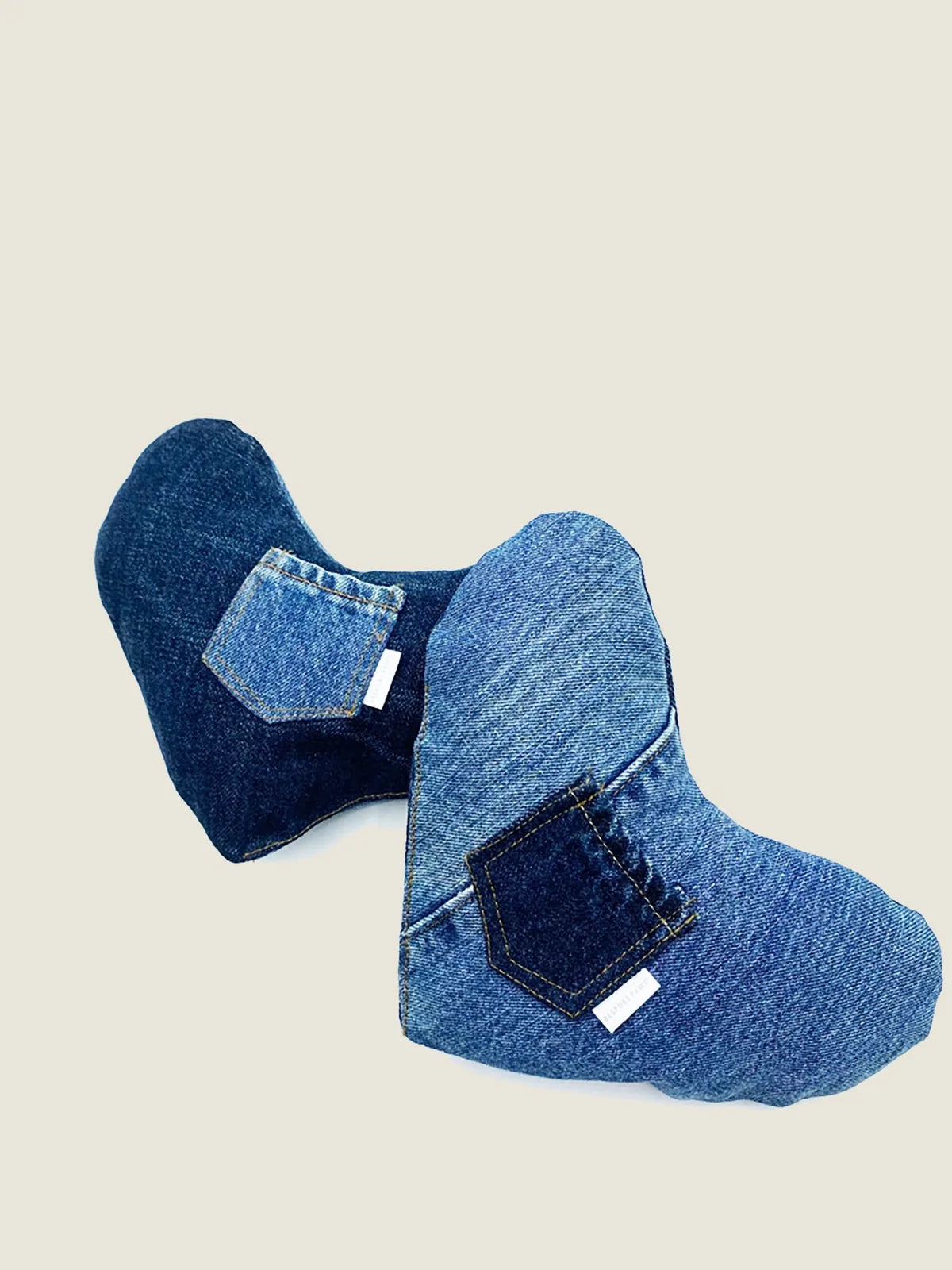 Plush heart-shaped dog toy made from upcycled denim, featuring two pockets and varying shades of blue.