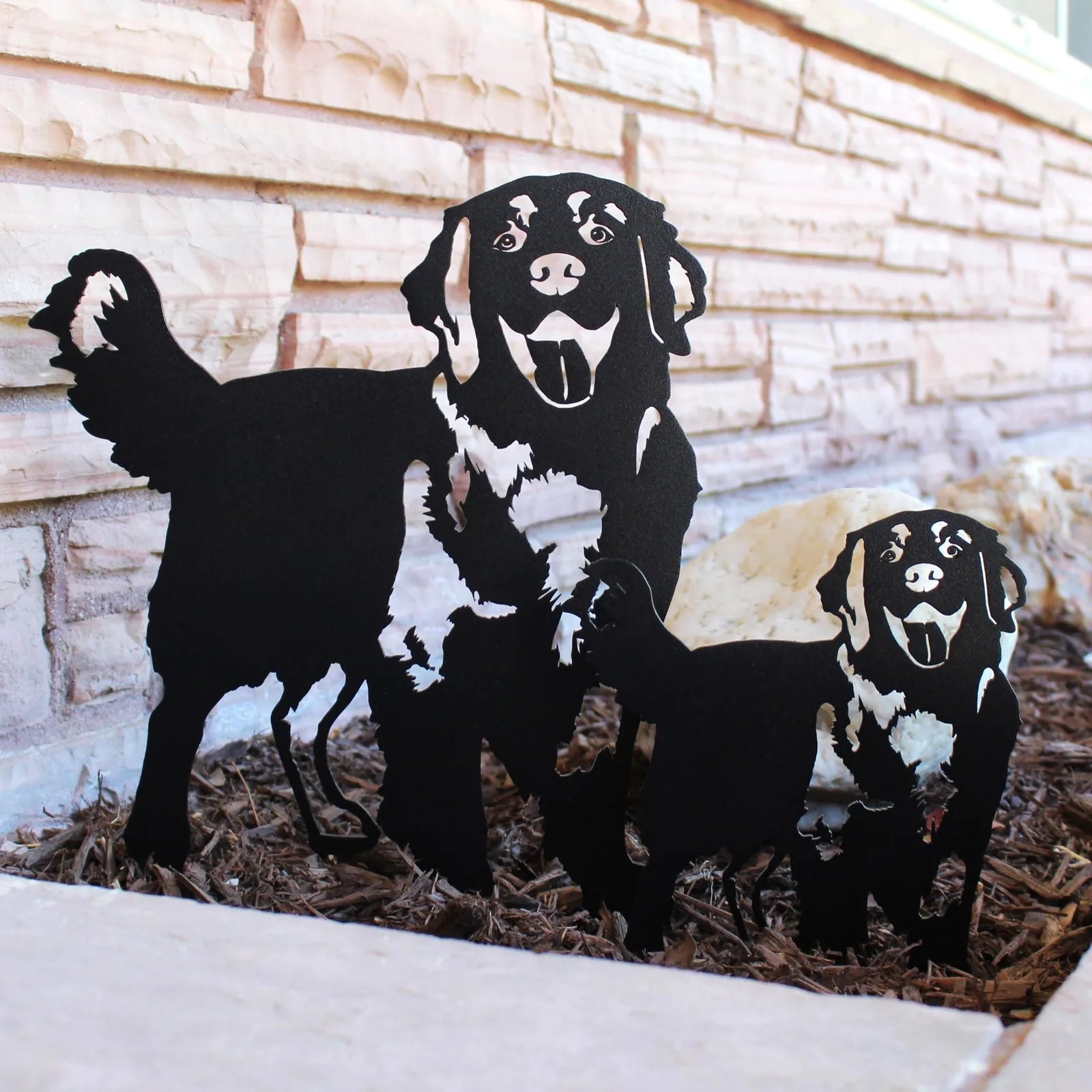 Handmade black Hovawart dog silhouettes, detailing playful poses, made from sturdy metal for outdoor decor.