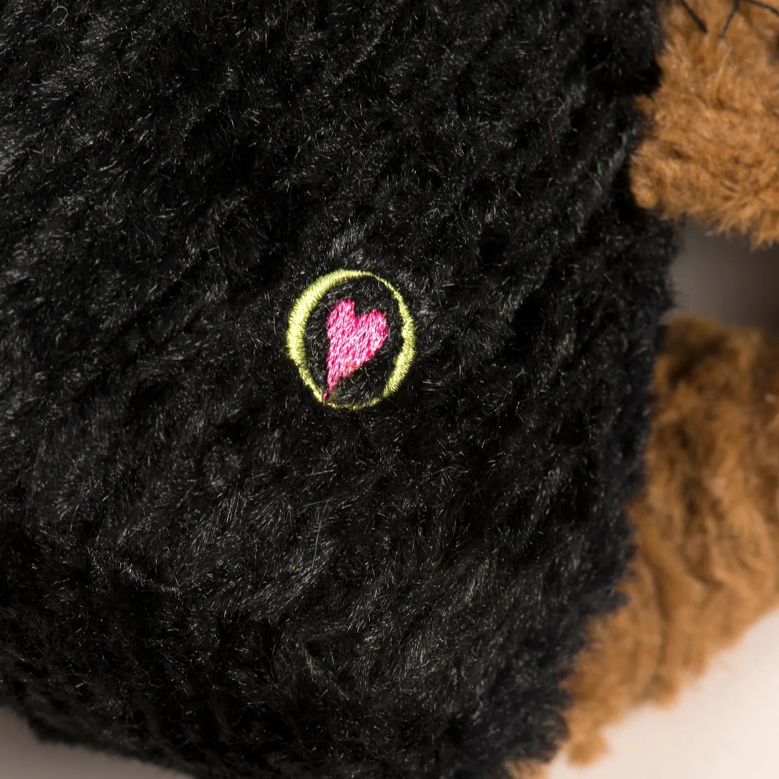 Close-up of the K-9 Chief Knottie® Plush Dog Toy's black plush fabric with an embroidered heart design.