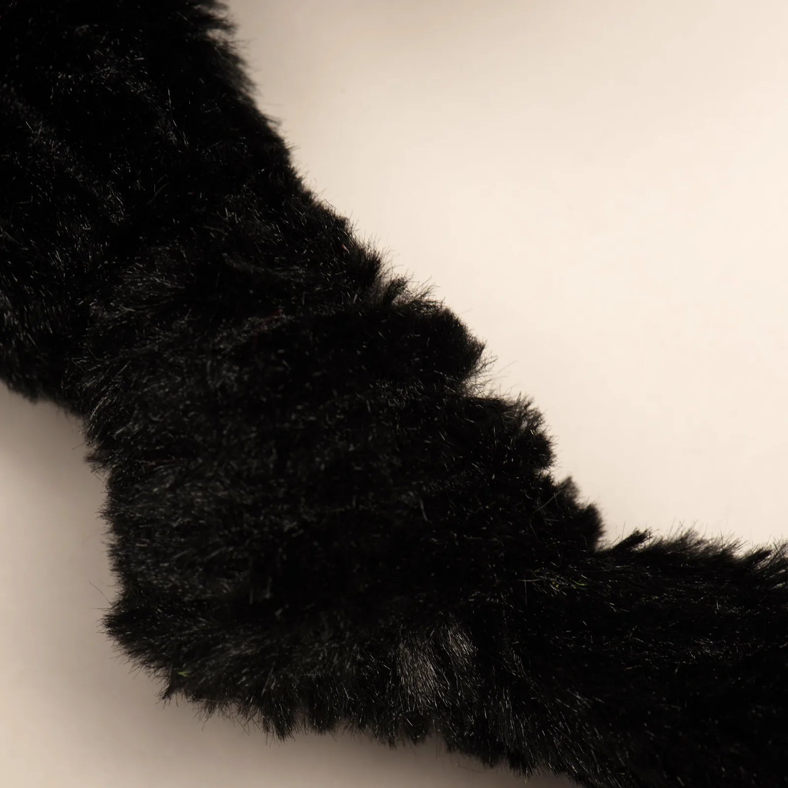 Soft black plush knotted limb section of the K-9 Mattis Knottie® dog toy, designed for interactive play.