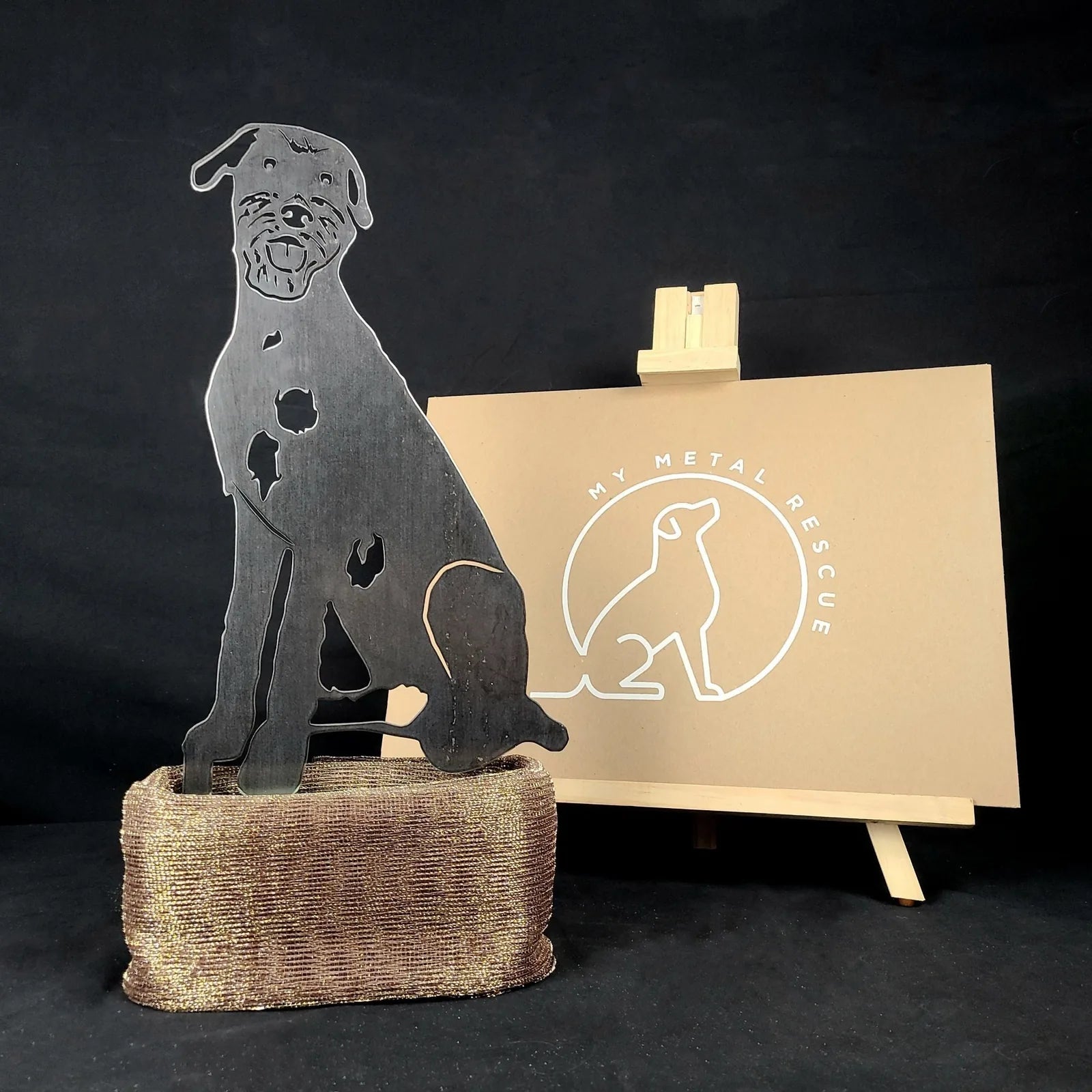 Black metal silhouette of an Irish Wolfhound on a textured bronze base, showcasing its detailed design for outdoor decor.