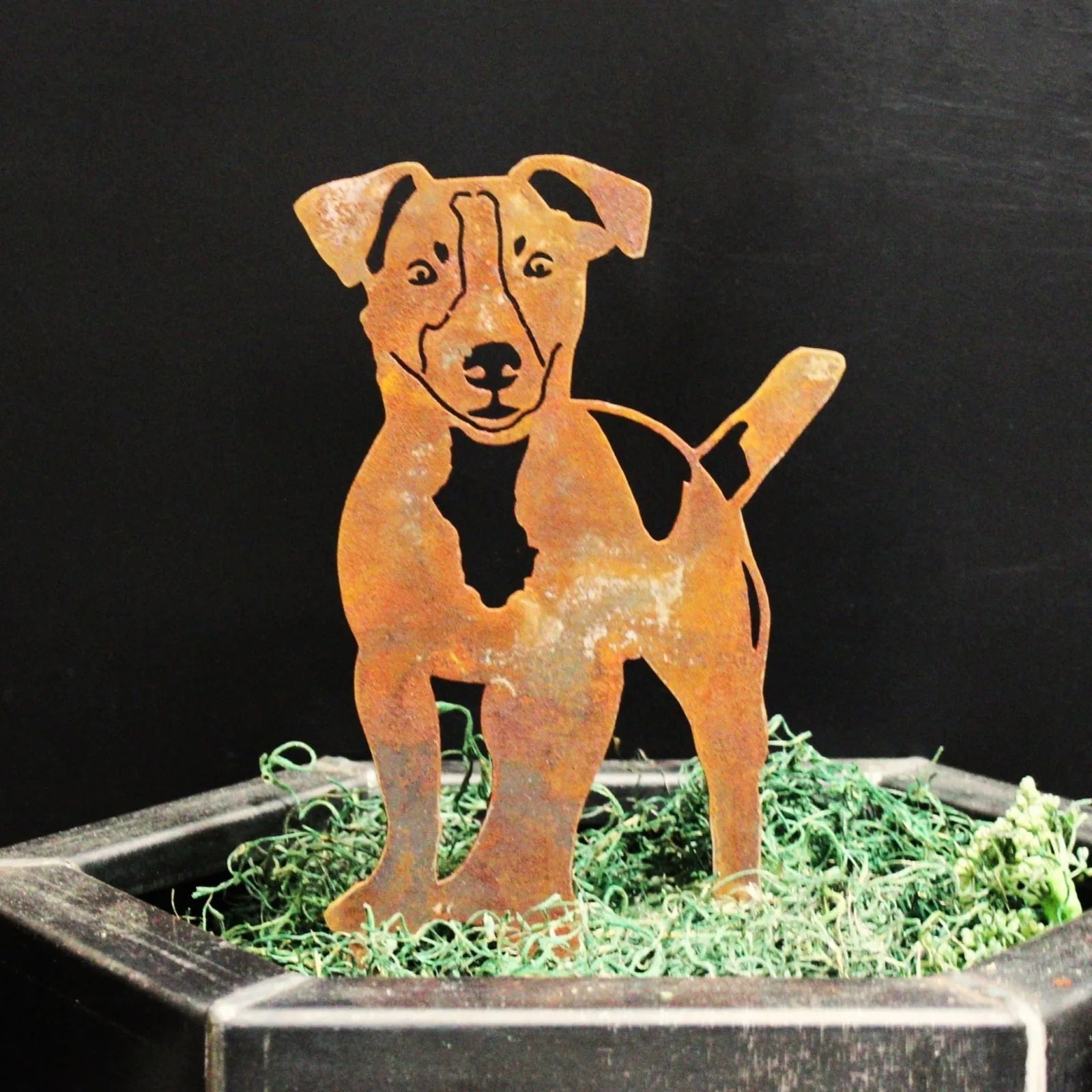 Jack Russell Terrier silhouette in weathered Corten steel, displayed in a planter with green moss.
