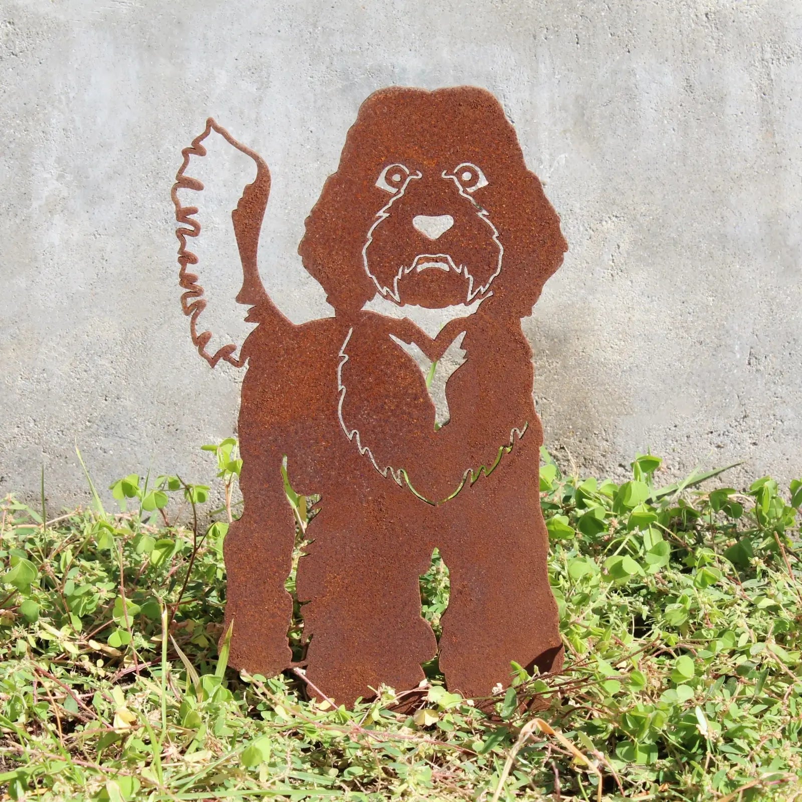 Rusty metal silhouette of a Labradoodle standing in grass, designed for outdoor decorative art by My Metal Rescue.