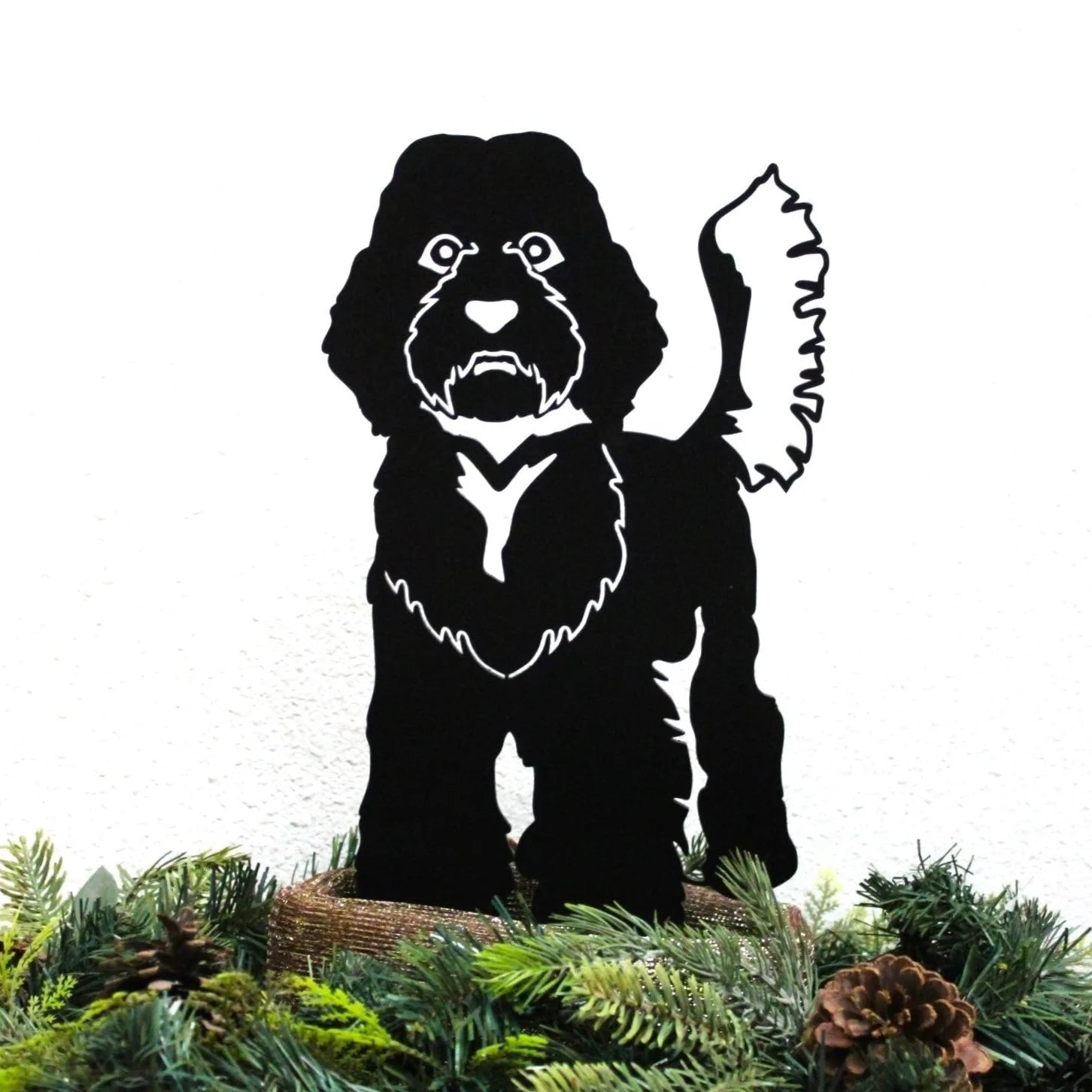 Black Labradoodle metal silhouette standing on greenery, showcasing detailed cutouts and a playful pose for outdoor decor.