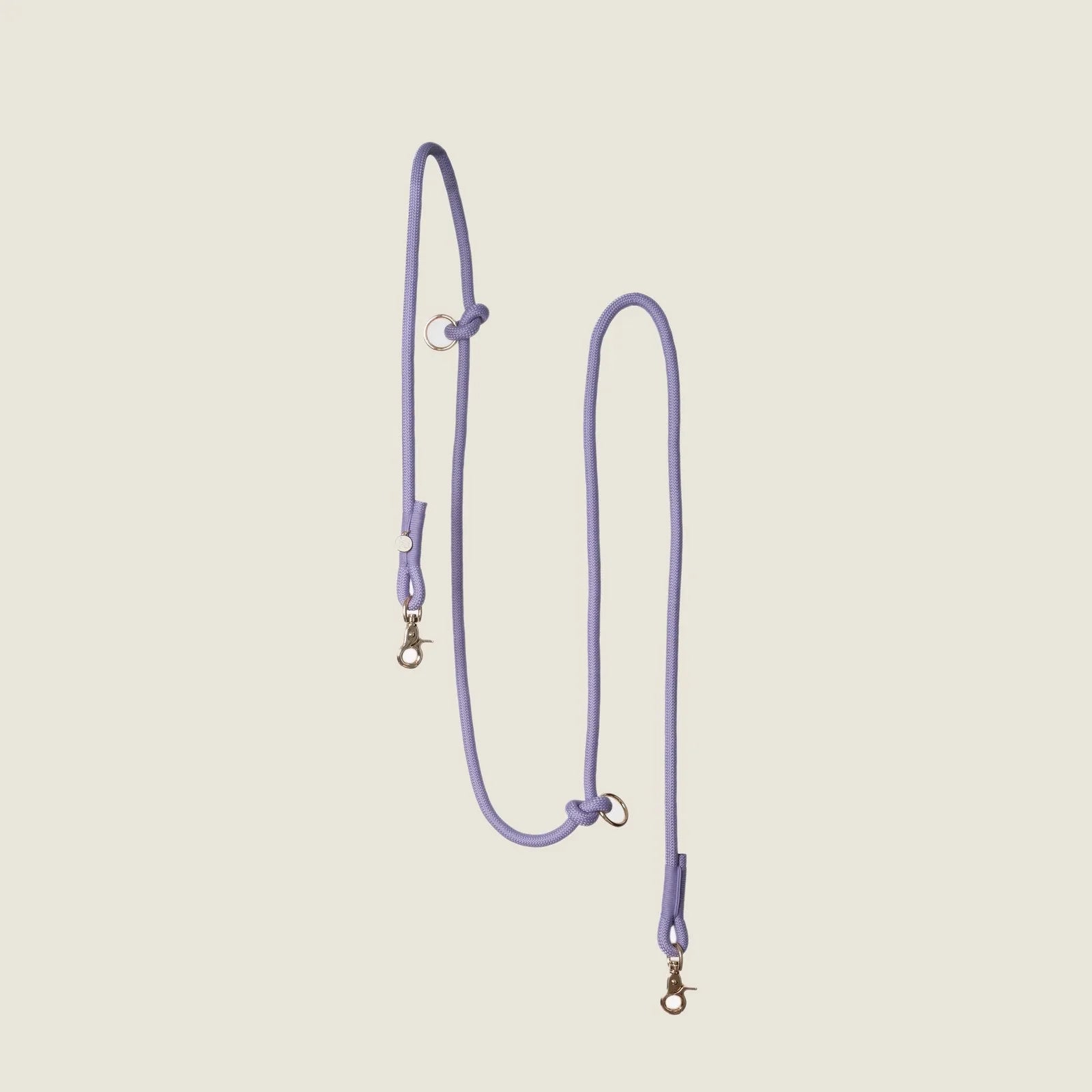 Lavender hands-free braided leash with golden clips, designed for convenience during walks or runs.