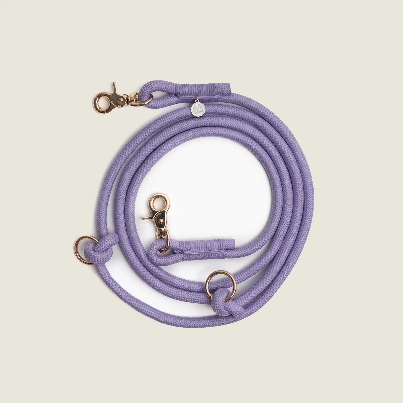 Hands-free braided leash in lavender with gold hardware, featuring multiple clips and loops for versatility.