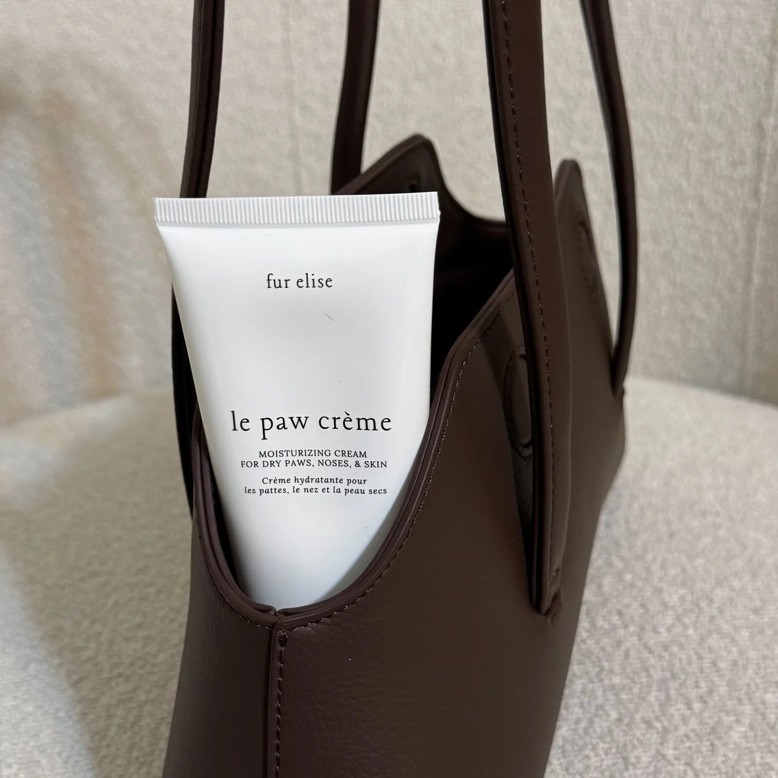 Le Paw Crème by Elise Galleria in a brown bag, designed for moisturizing dry paws, noses, and skin.
