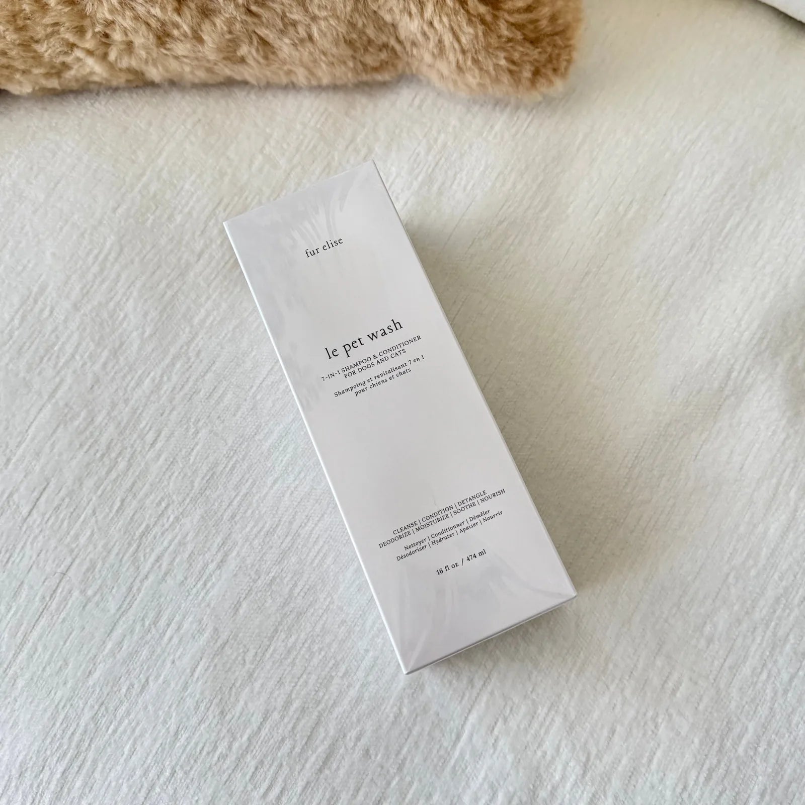 Le Pet Wash by Elise Galleria in a sleek white bottle on a soft white background, featuring elegant minimalist design.