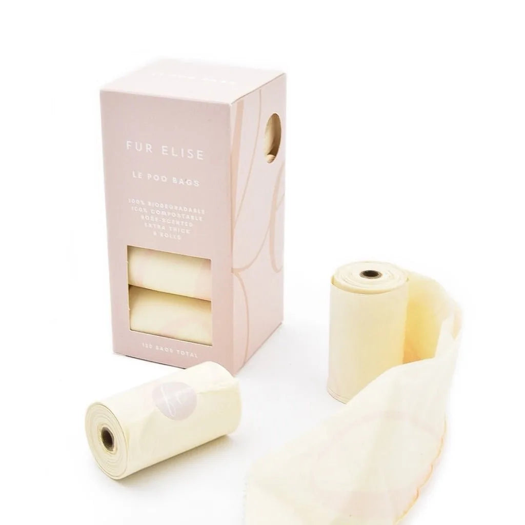 Biodegradable Le Poo Bags in a pastel box, featuring rolls of lightly rose-scented pet waste bags.