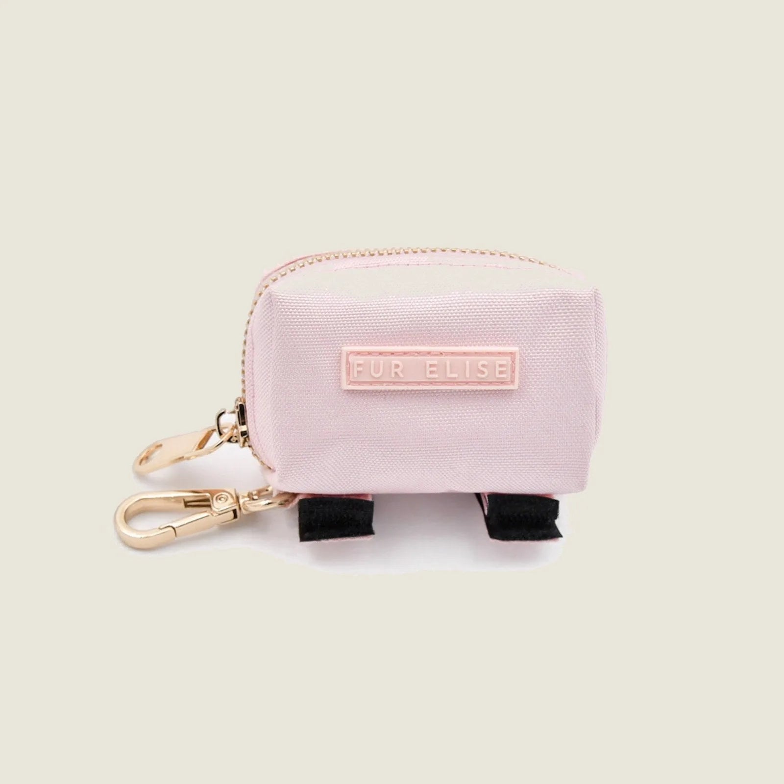 Light pink Le Poo Pouch made of Oxford fabric with gold clasp, featuring a "FUR ELISE" label and black Velcro ties.