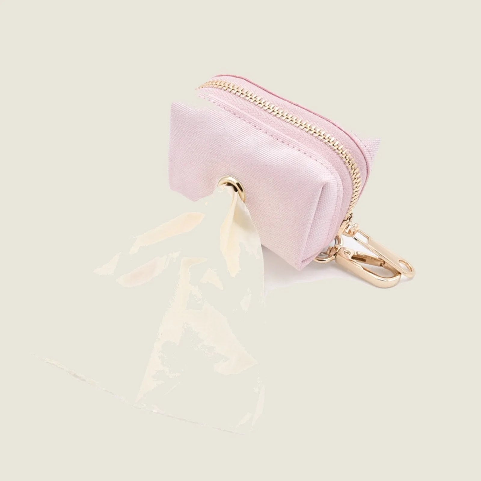 Durable light pink Le Poo Pouch with gold zipper, holding a rose-scented waste bag, ideal for stylish dog walks.