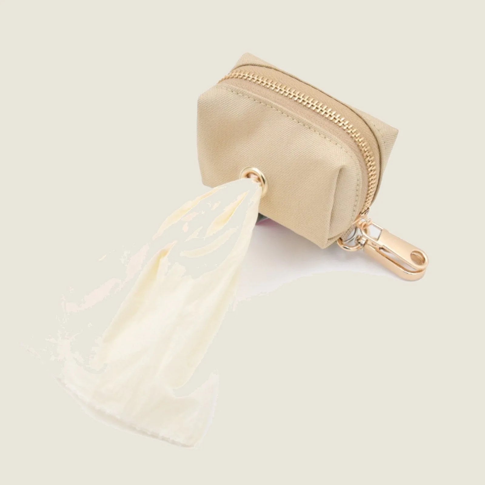 Durable beige Le Poo Pouch with a gold zipper, attached to a white biodegradable bag, designed for pet waste disposal.