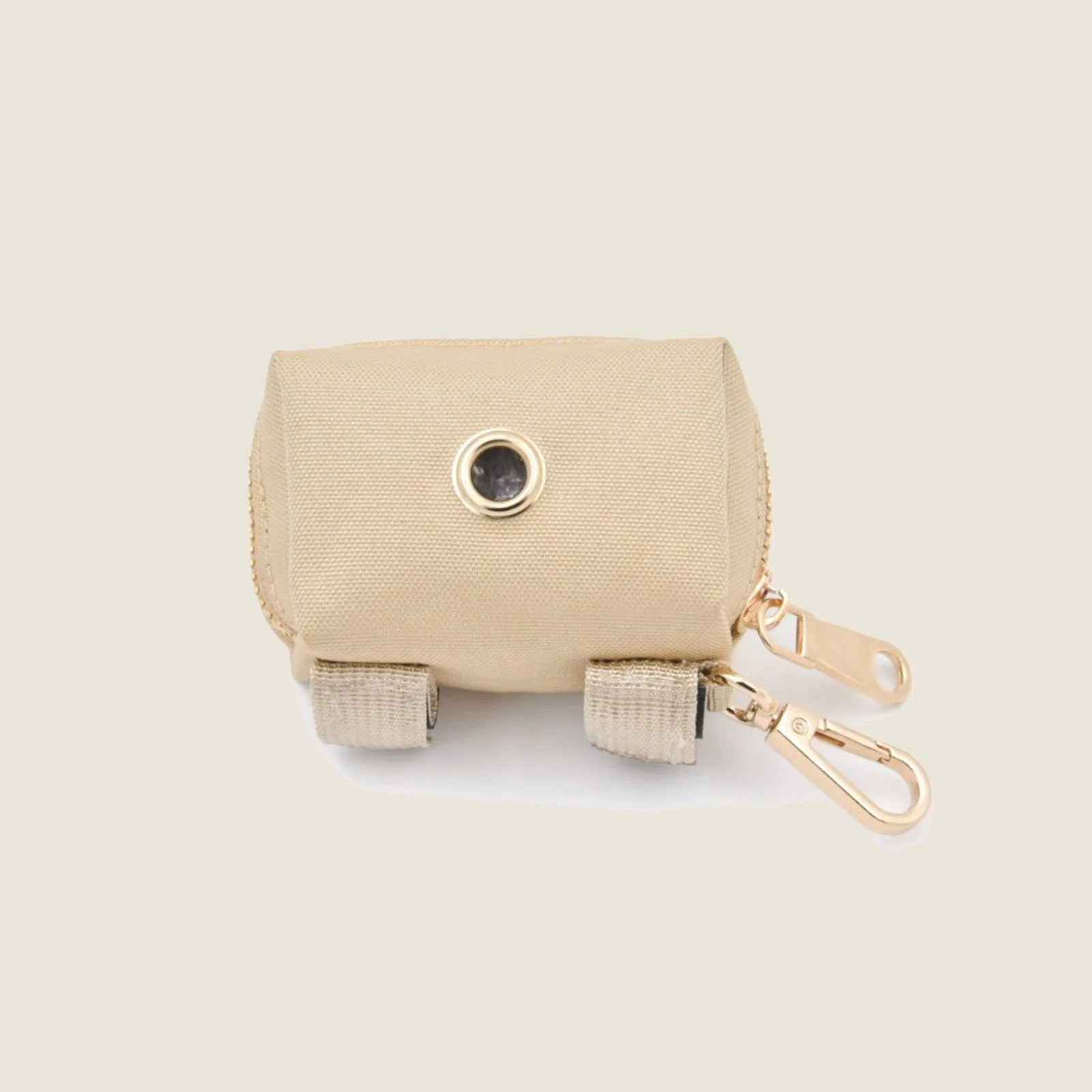 Durable beige Le Poo Pouch with gold clasps, designed for carrying biodegradable dog waste bags during walks.