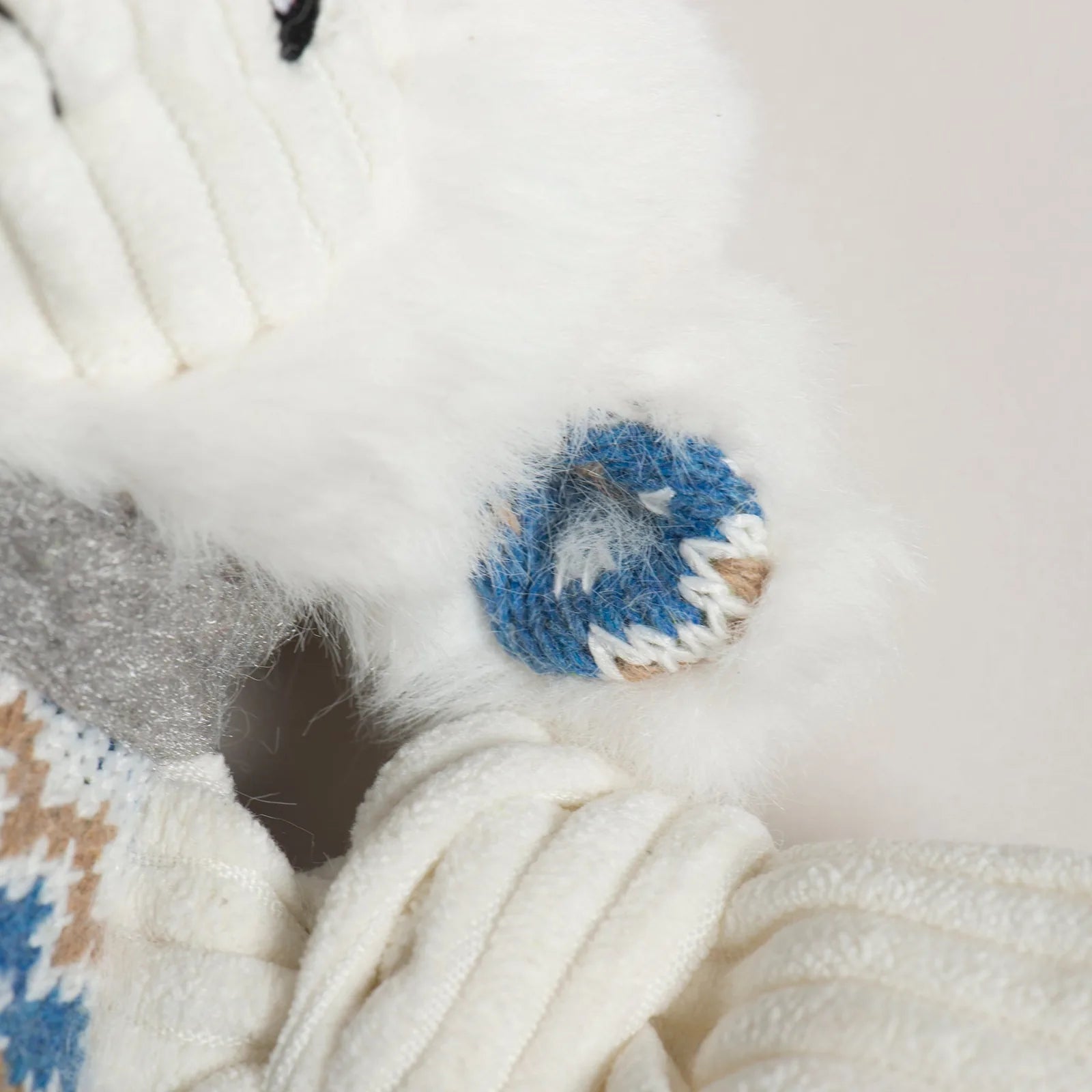 Close-up of Leo Lamb plush dog toy showcasing soft ivory fur, blue sweater, and knotted limbs for playful tugging.