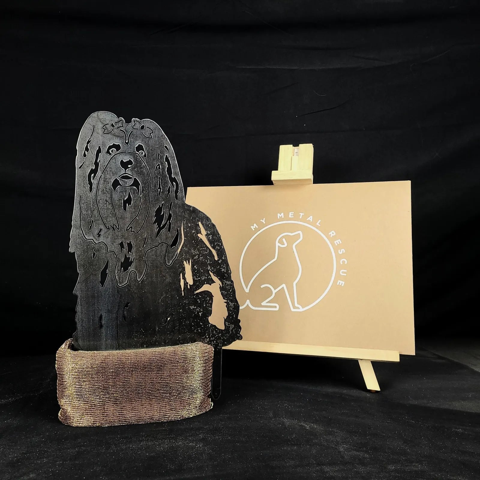 Lhasa Apso metal silhouette made of black Corten steel, showcasing detailed cutouts, set against a neutral background.
