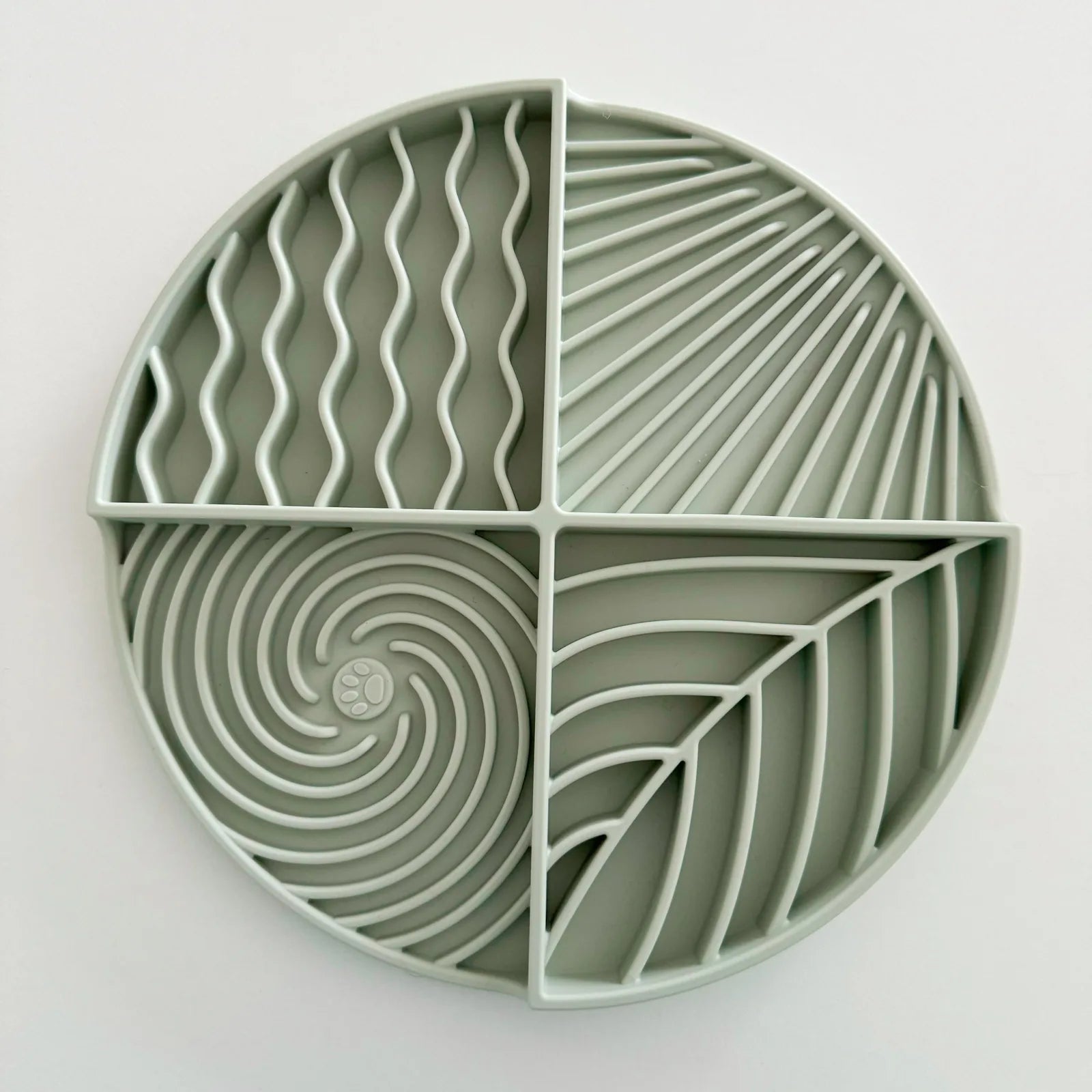 Light green Lick Mat Circle features four textured sections for engaging pets during mealtime or playtime.