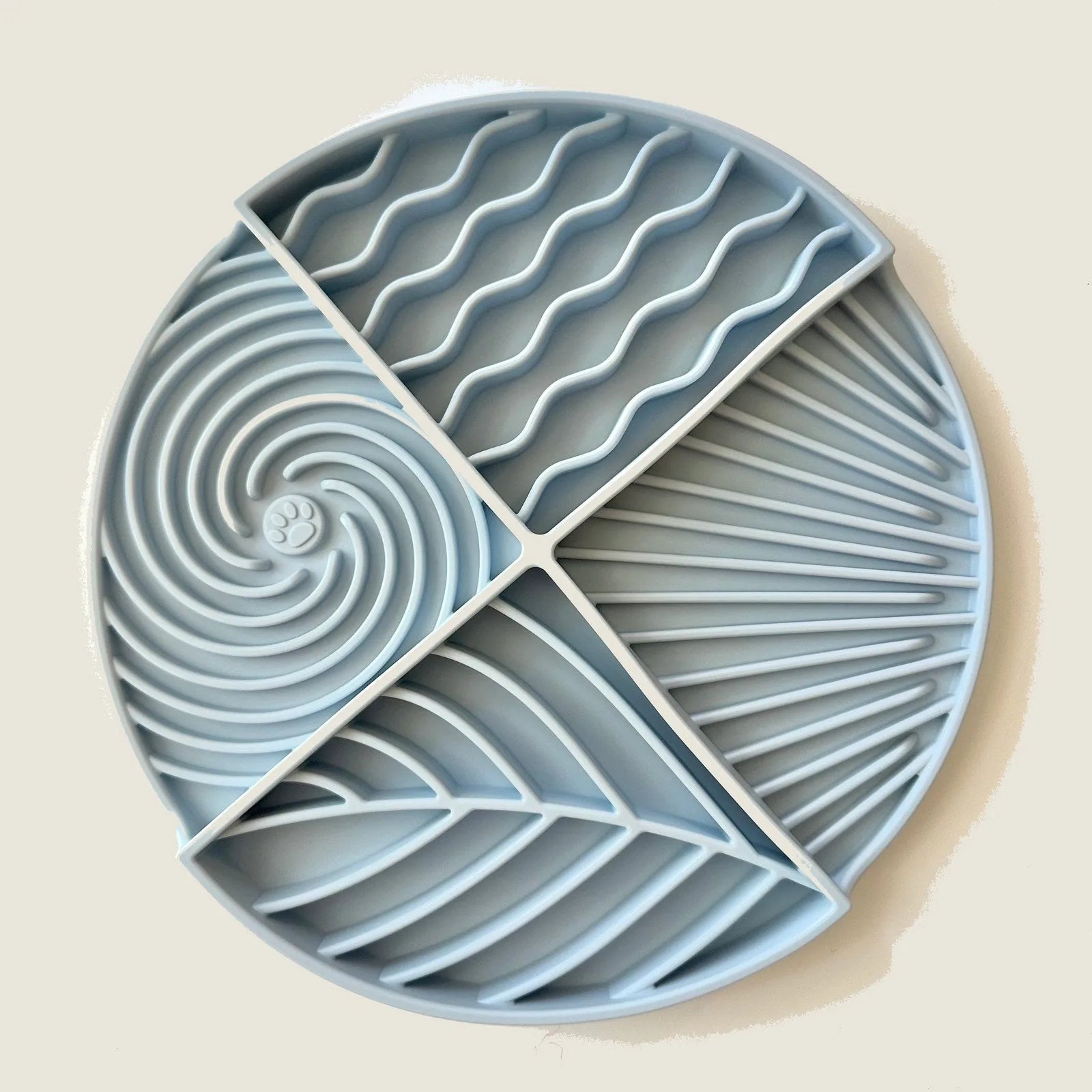 Baby blue circular lick mat with various textured sections designed for dog entertainment and mental stimulation.