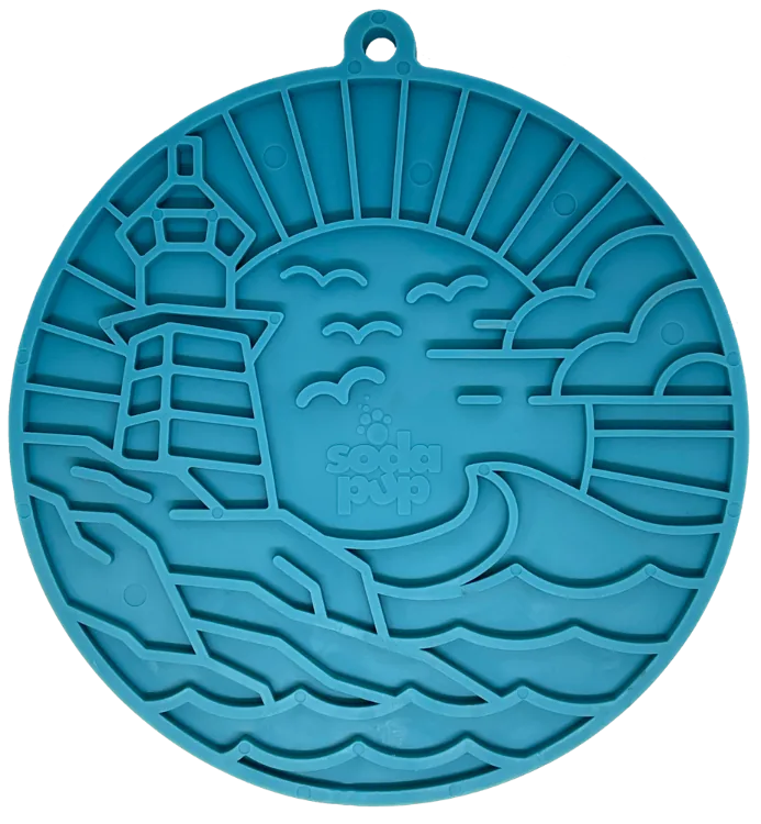 Lighthouse-shaped dark blue enrichment lick mat with textured surface and suction cups for secure placement.