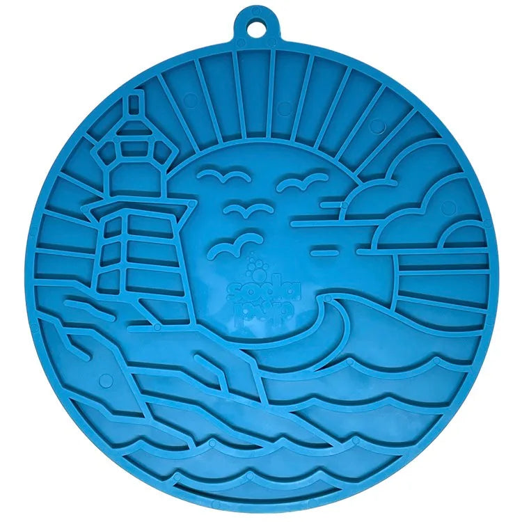 Dark blue lighthouse-themed lick mat with textured surface and suction cups for secure placement on smooth surfaces.