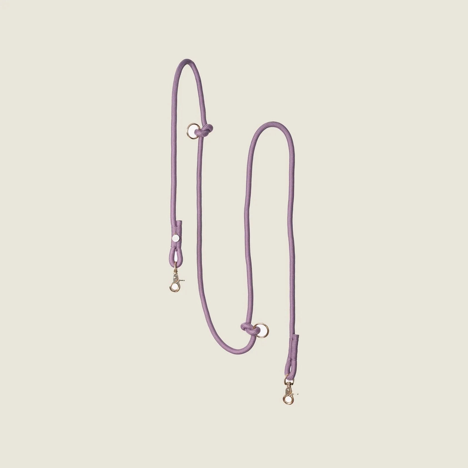 Lilac braided leash with gold clips, designed for hands-free walking and adjustable for waist or shoulder use.