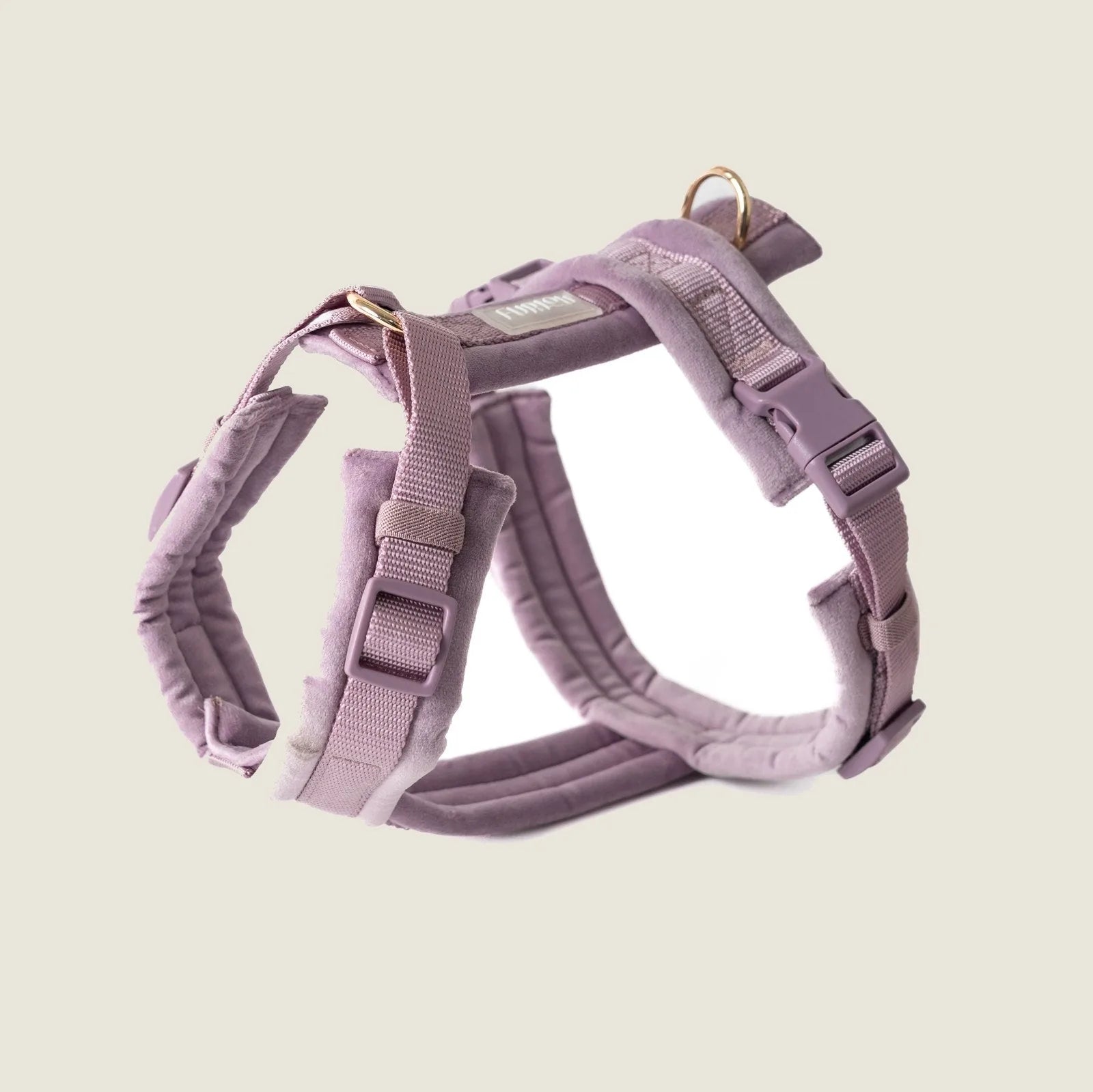 Lilac velvet dog harness with gold hardware and adjustable straps, designed for comfort during walks.